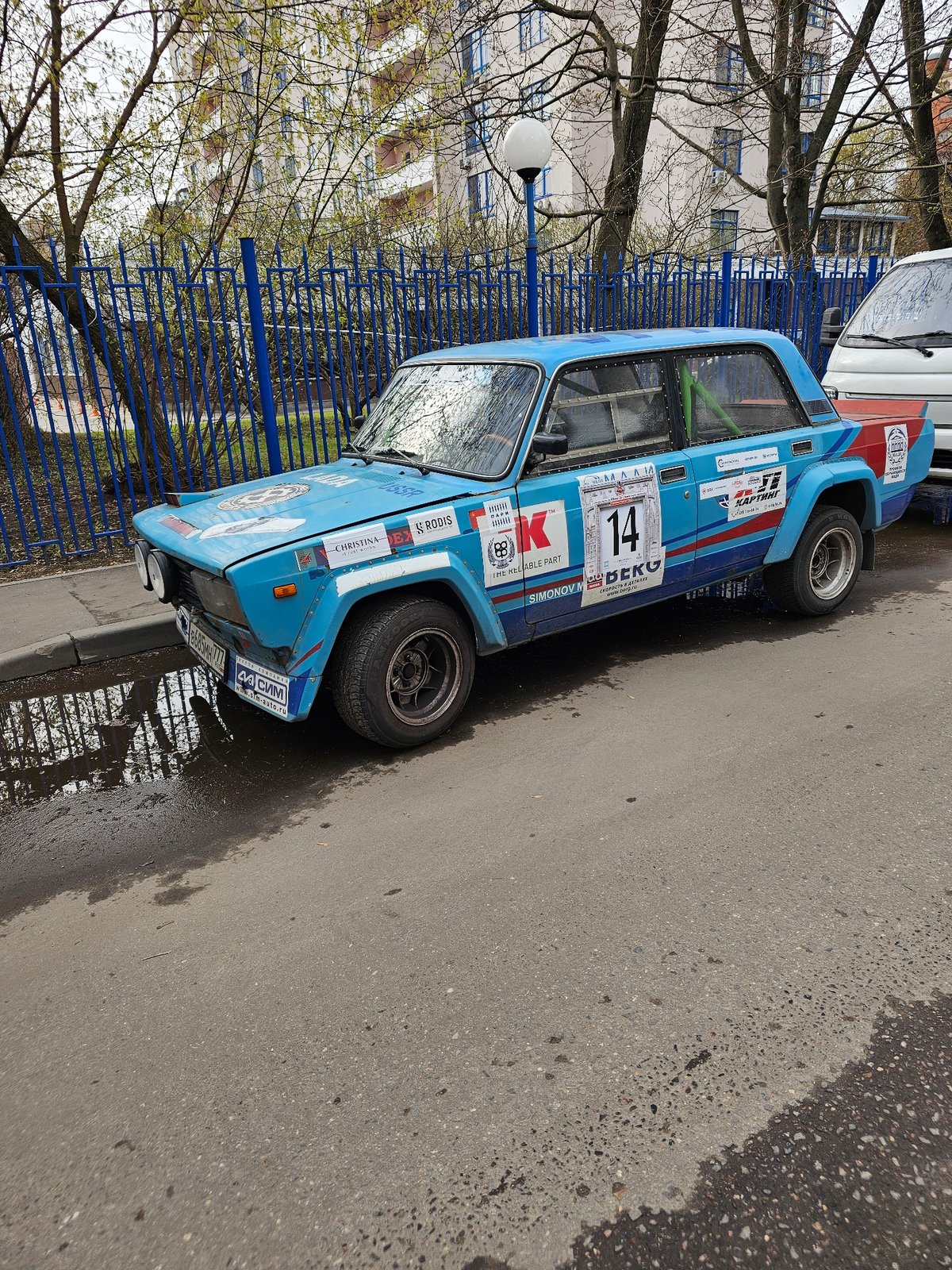 Rally car spotted on urban street amid spring scenes