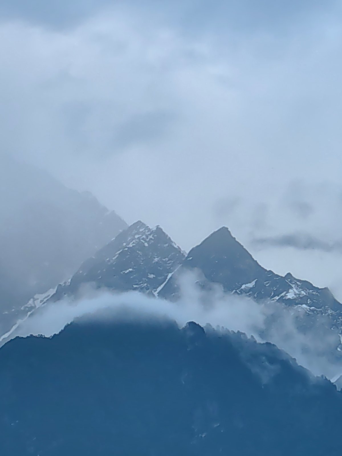 Misty mountain views across Vashisht village during cloudy afternoon