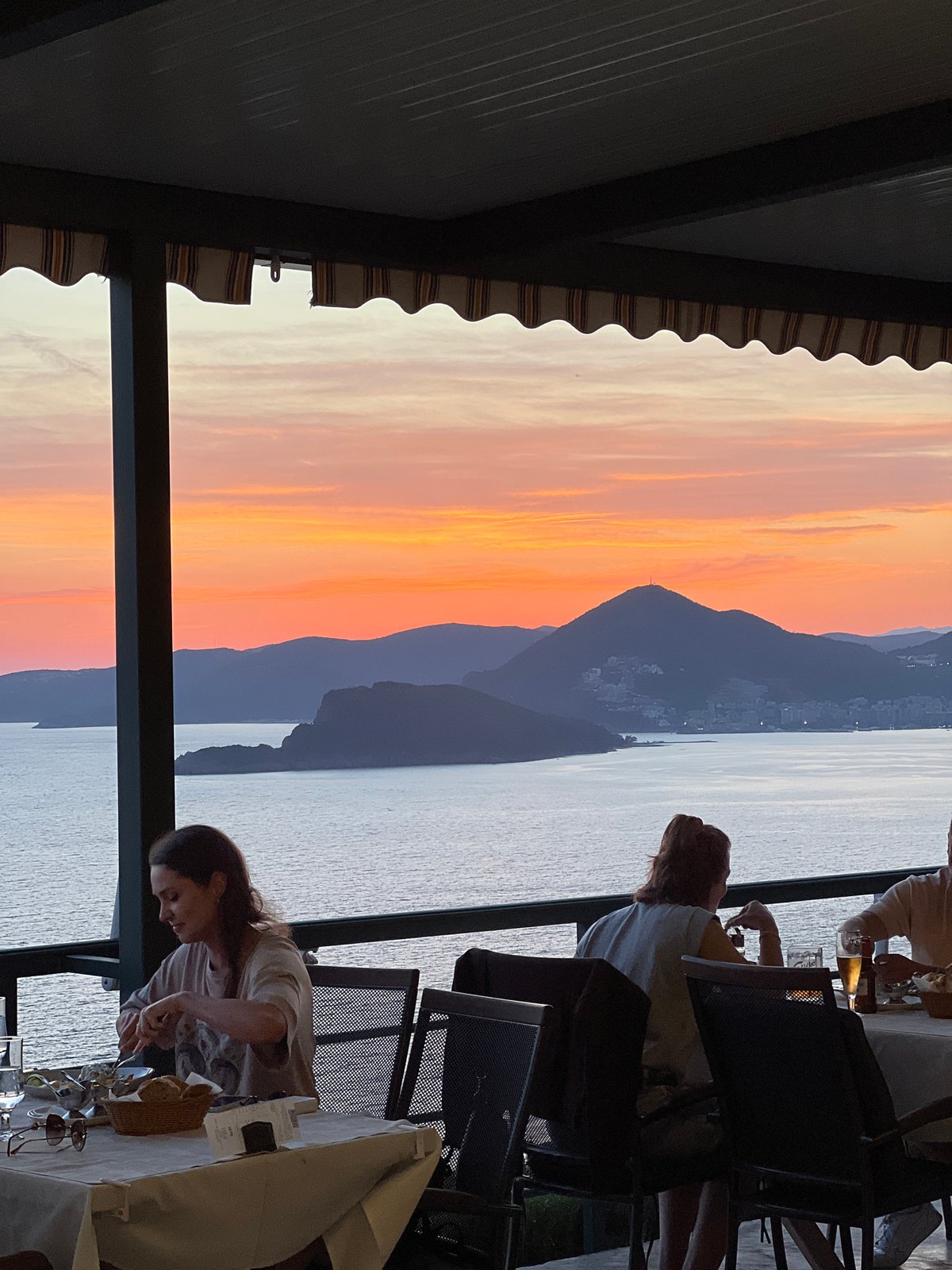 Evening diners enjoy sunset meal at Sveti Stefan restaurant