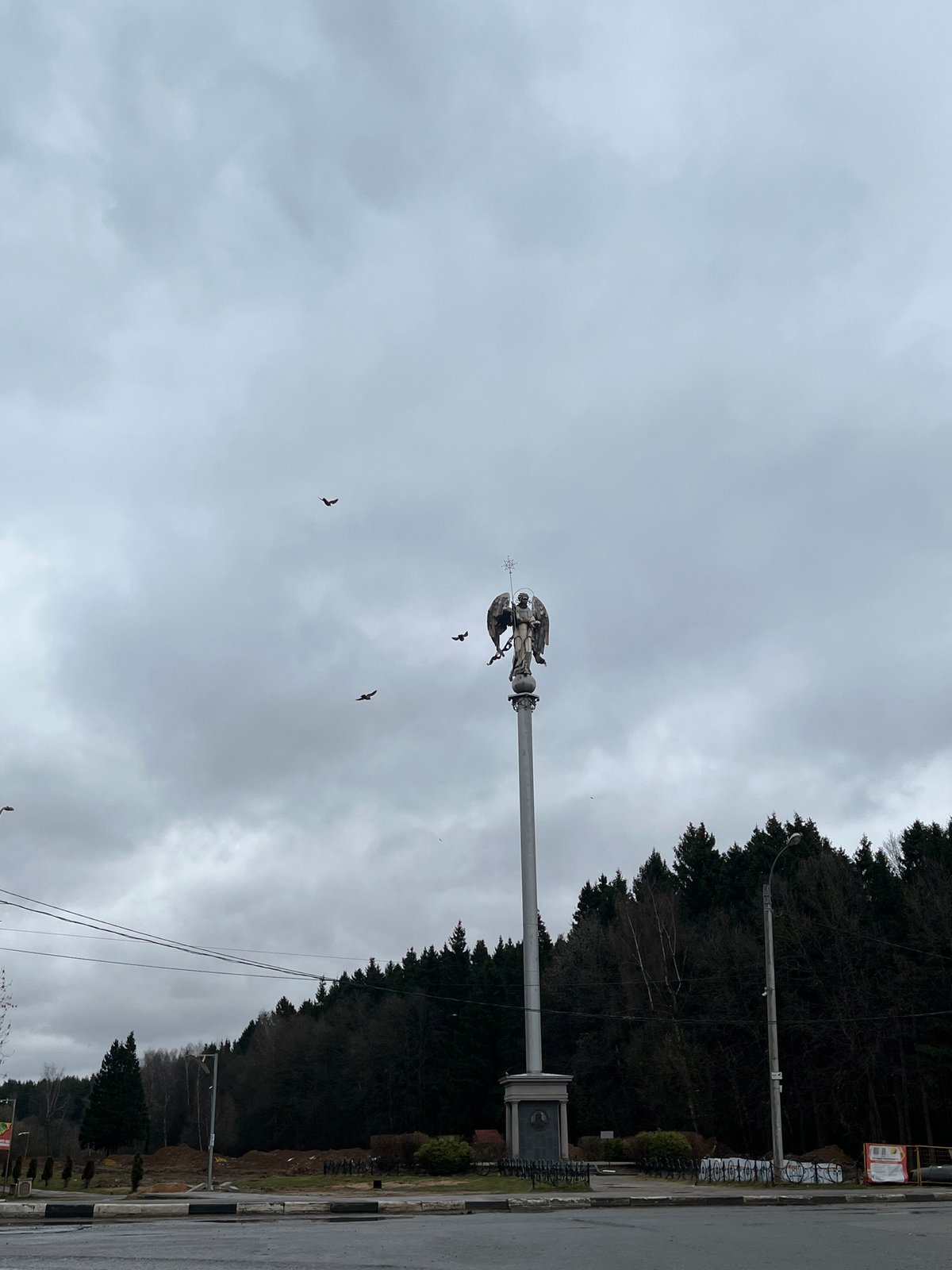 Birds circle angel monument in Podolsk park