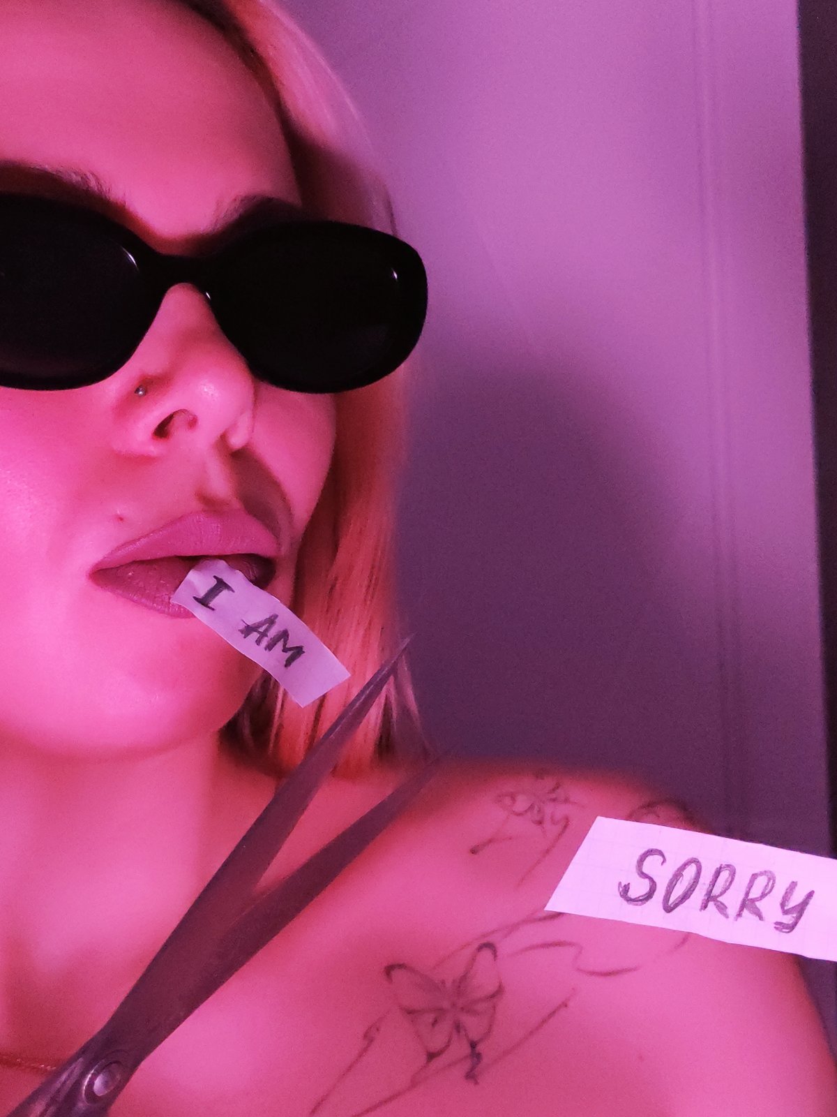 Person displays apology message with paper signs in Chaikovsky
