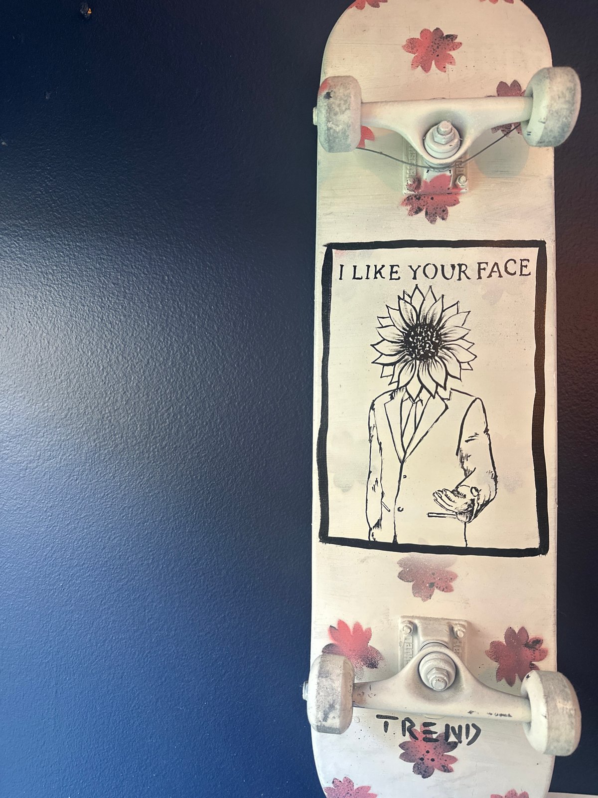 Woman photographs decorative skateboard display in Boca Raton home