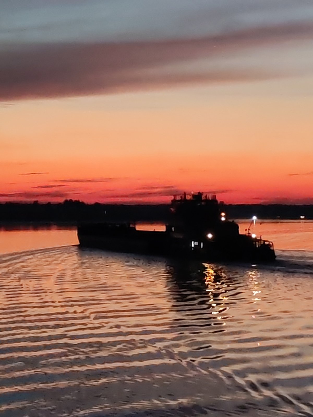 Barge navigates Russian waters at dusk near Babnya