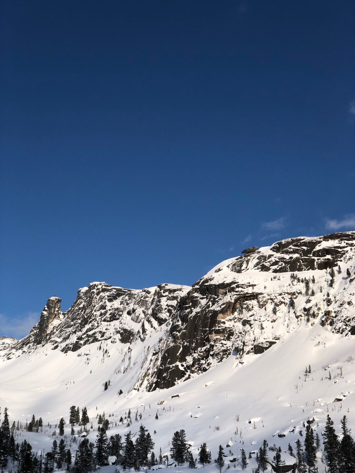 Snow-covered Russian mountains documented under clear blue skies
