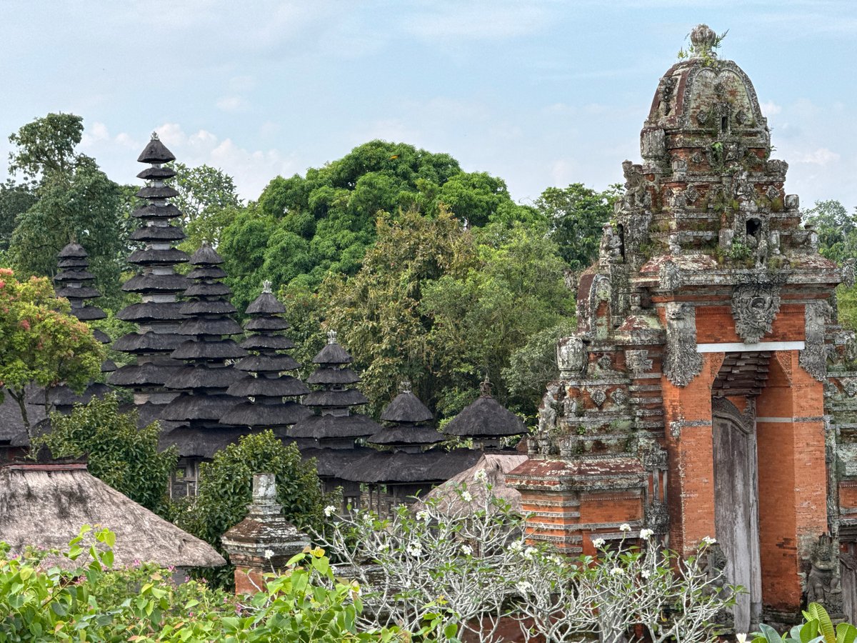 Tourist documents temple visit and nature interaction in Bali