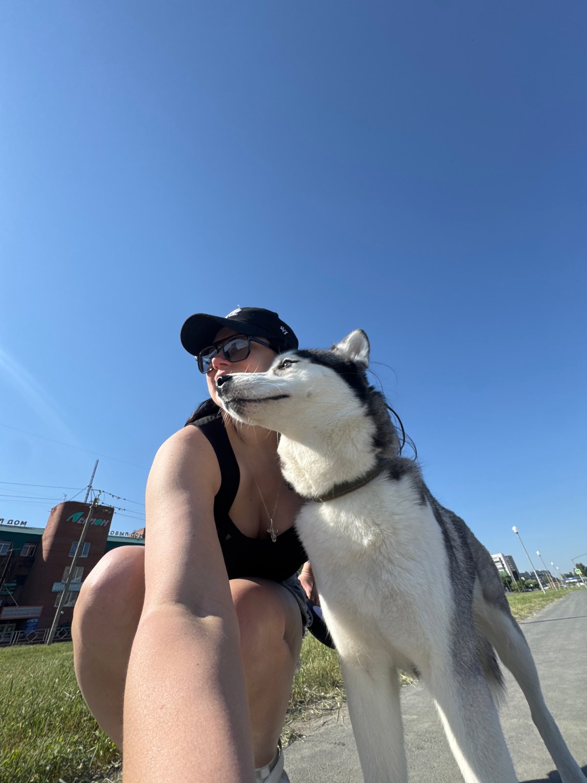 Woman and husky dog spotted during urban morning walk