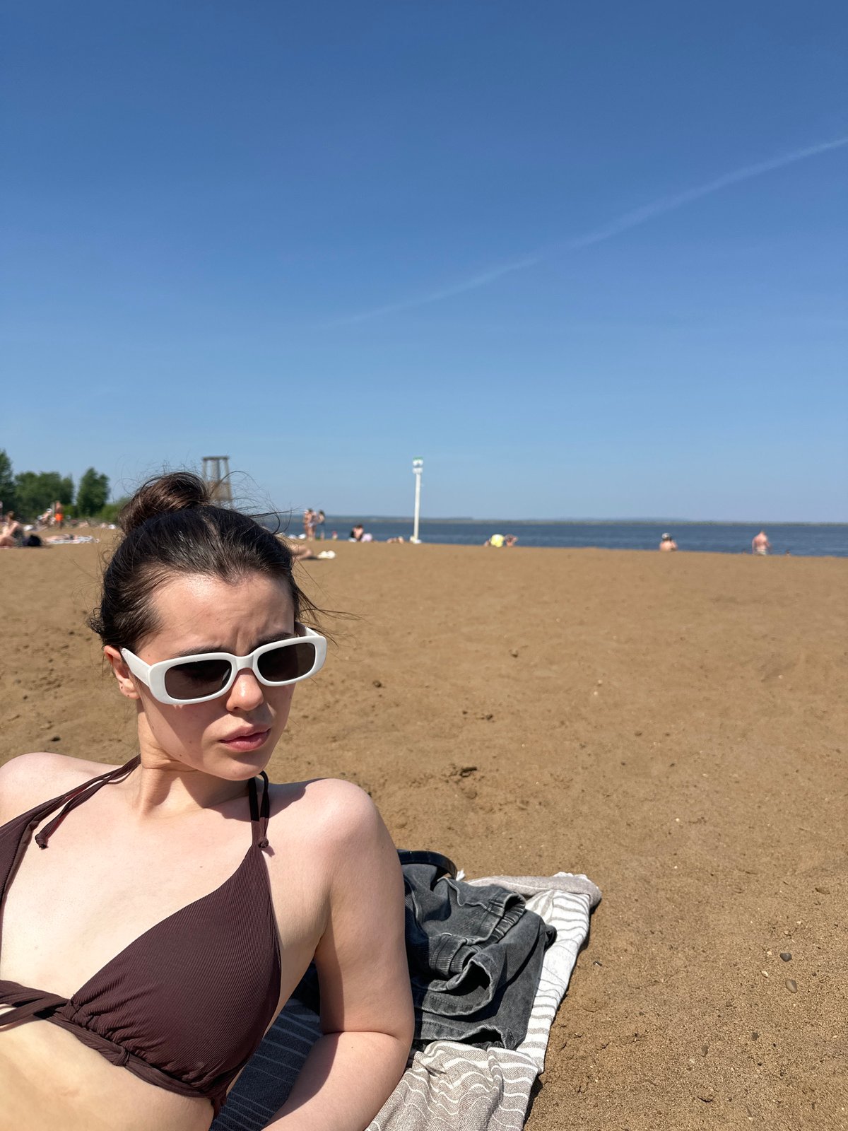 Woman photographed at multiple Chaikovsky waterfront locations over 13 minutes