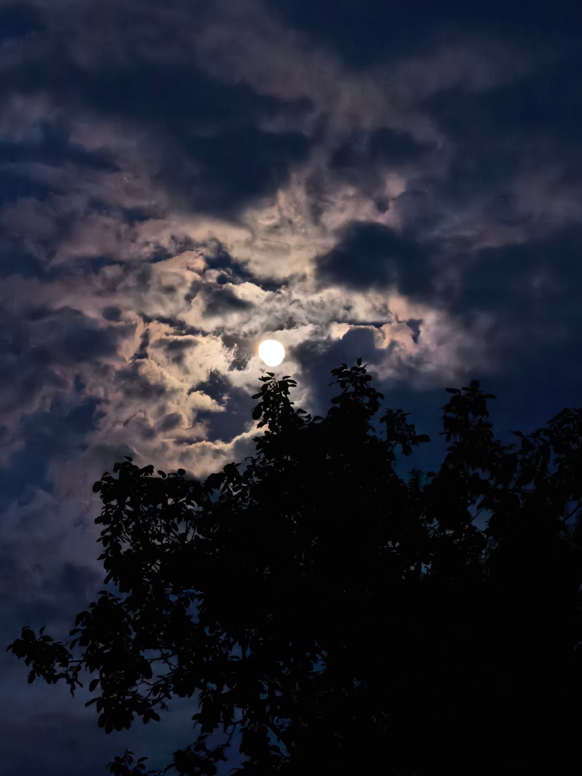 Full moon photographed through clouds in Svishtov, Bulgaria