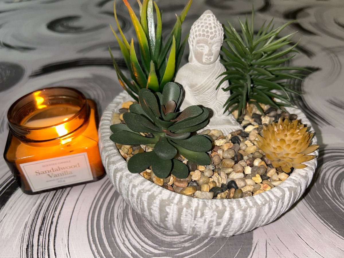 Buddha statue and candlelight in a styled tabletop arrangement