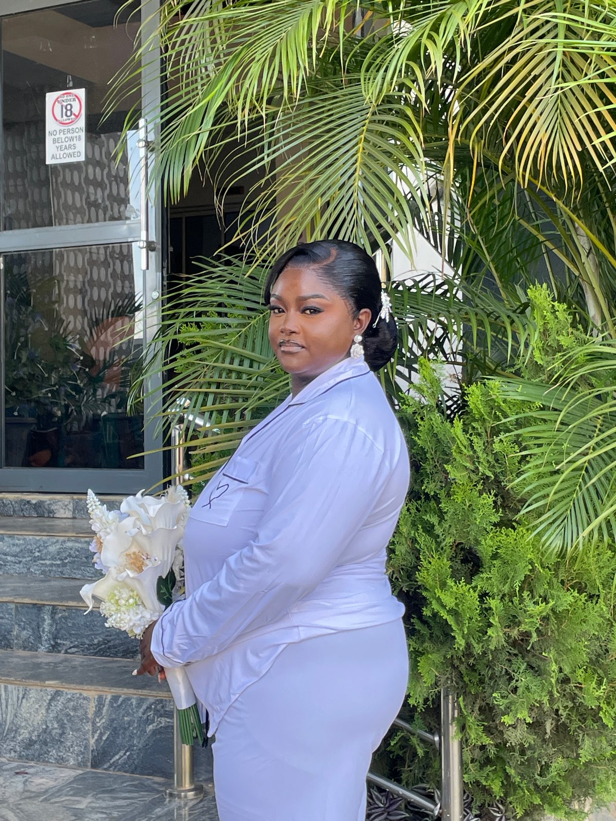 Woman with white flowers photographed in Jos, Nigeria