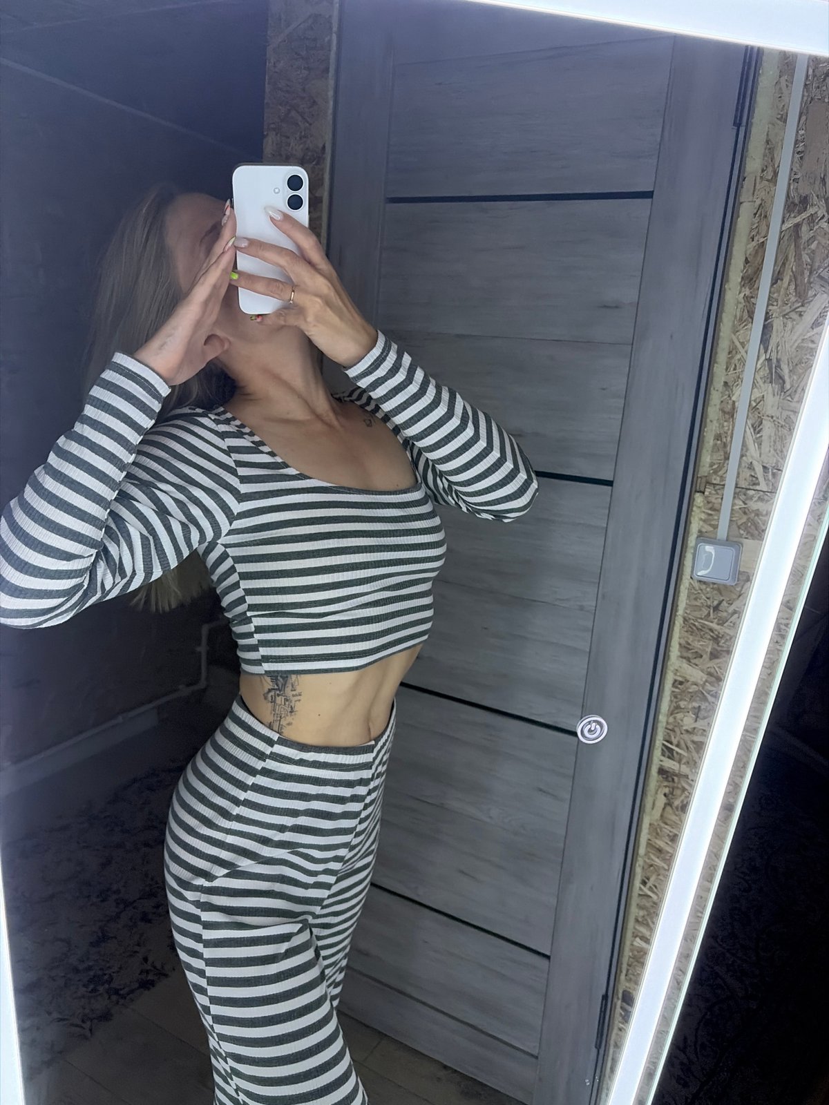 Woman takes selfies in wood-paneled room in Chaikovsky, Russia