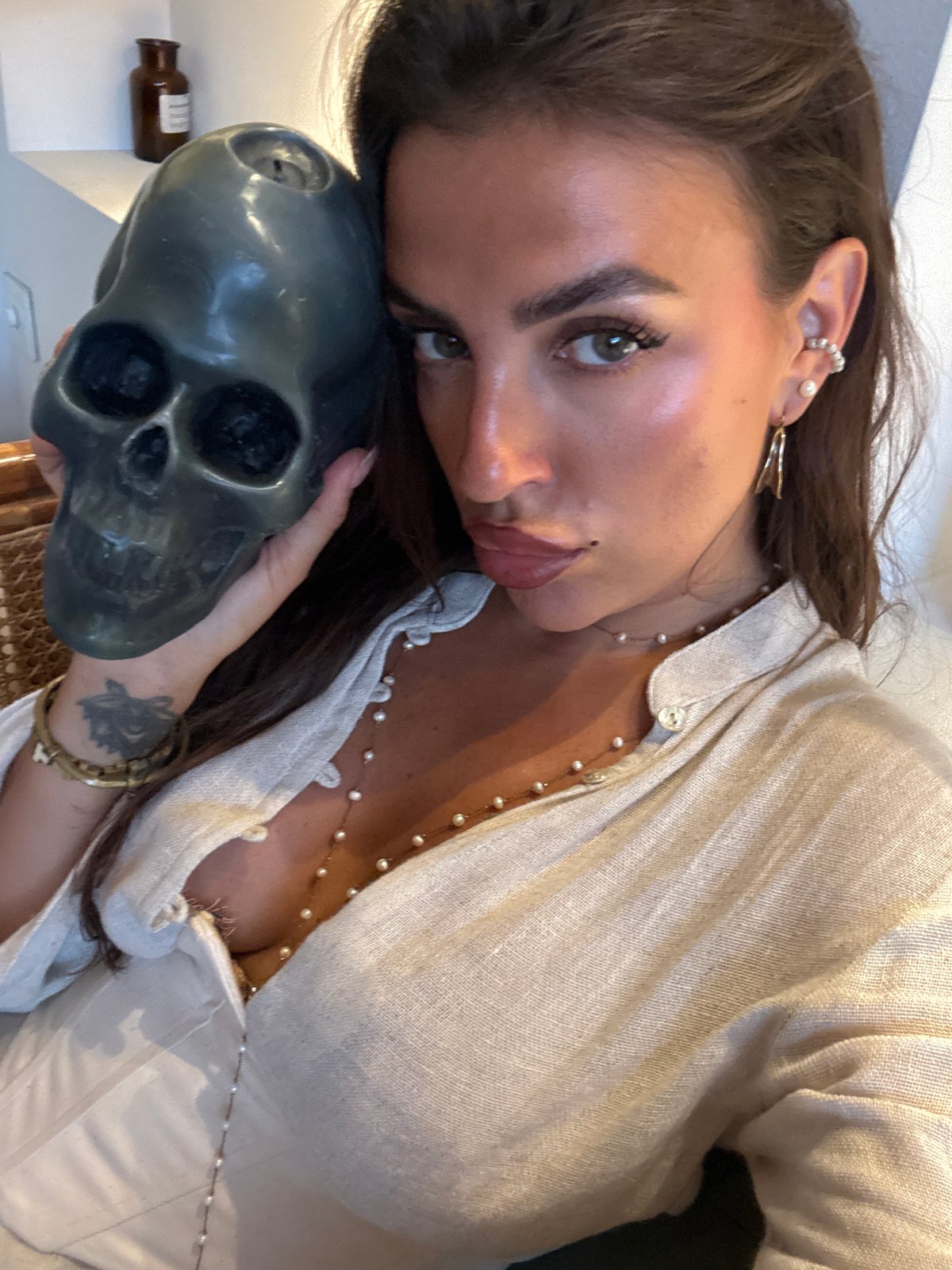 Woman poses with skull in multiple photos in North Kuta