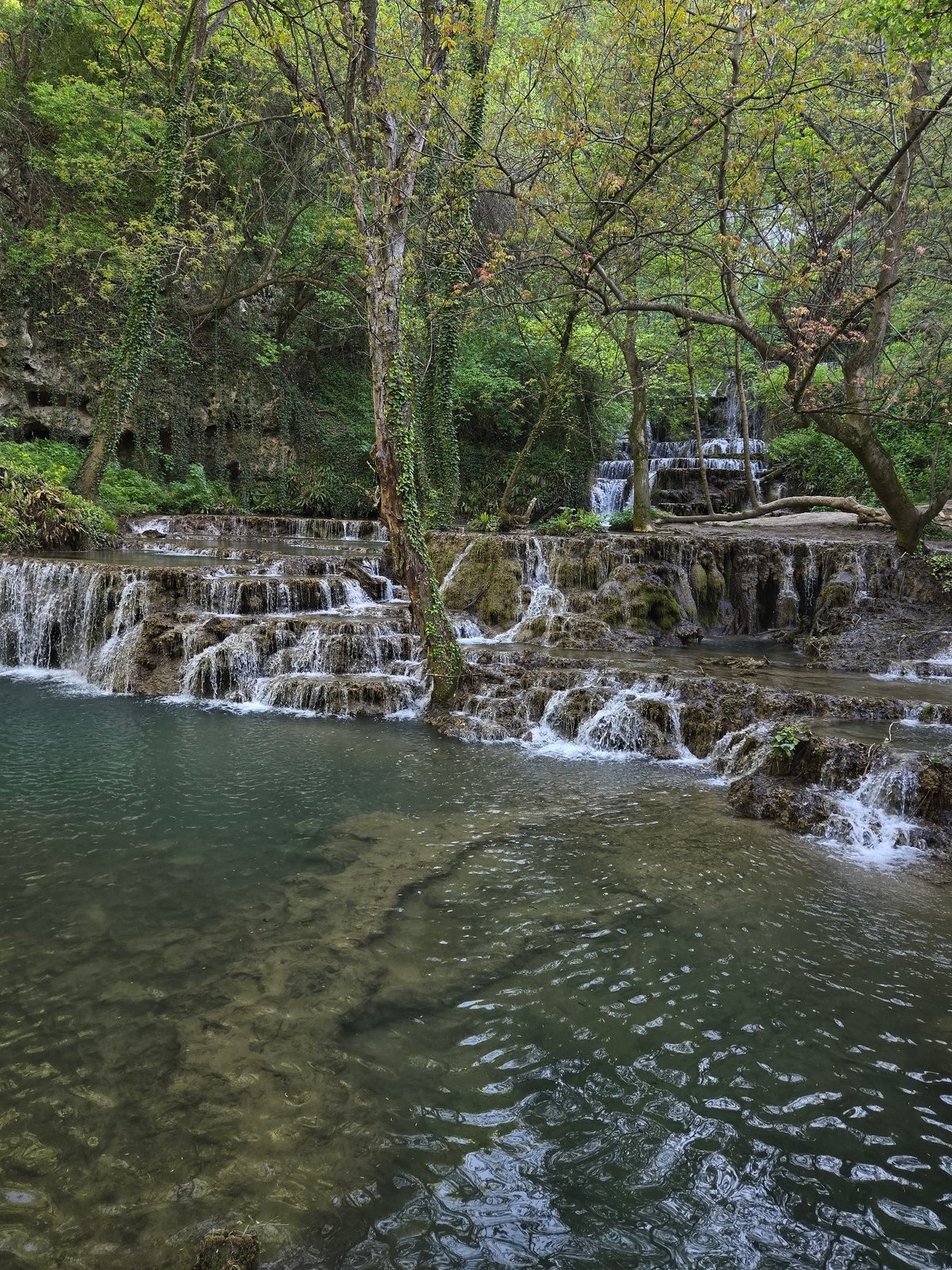 Multi-tiered waterfall with Cyrillic signage documented by witnesses
