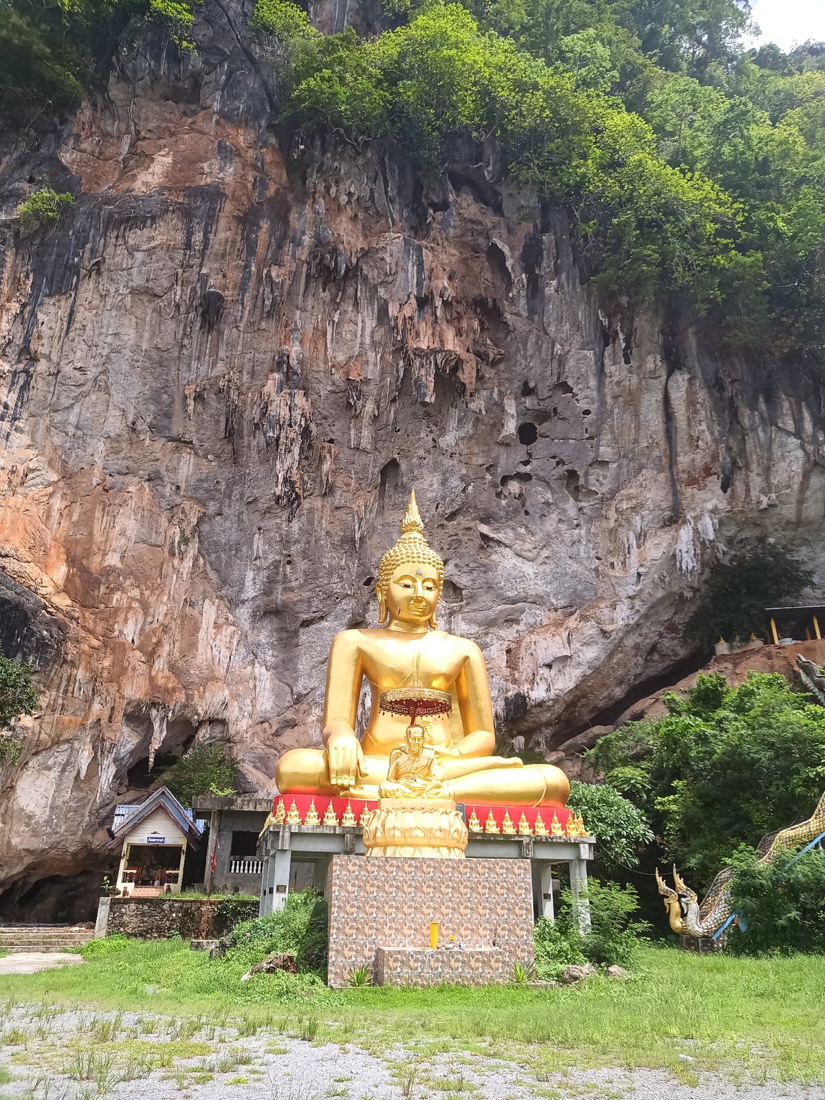 Golden Buddha statues documented at Thai cliffside temple