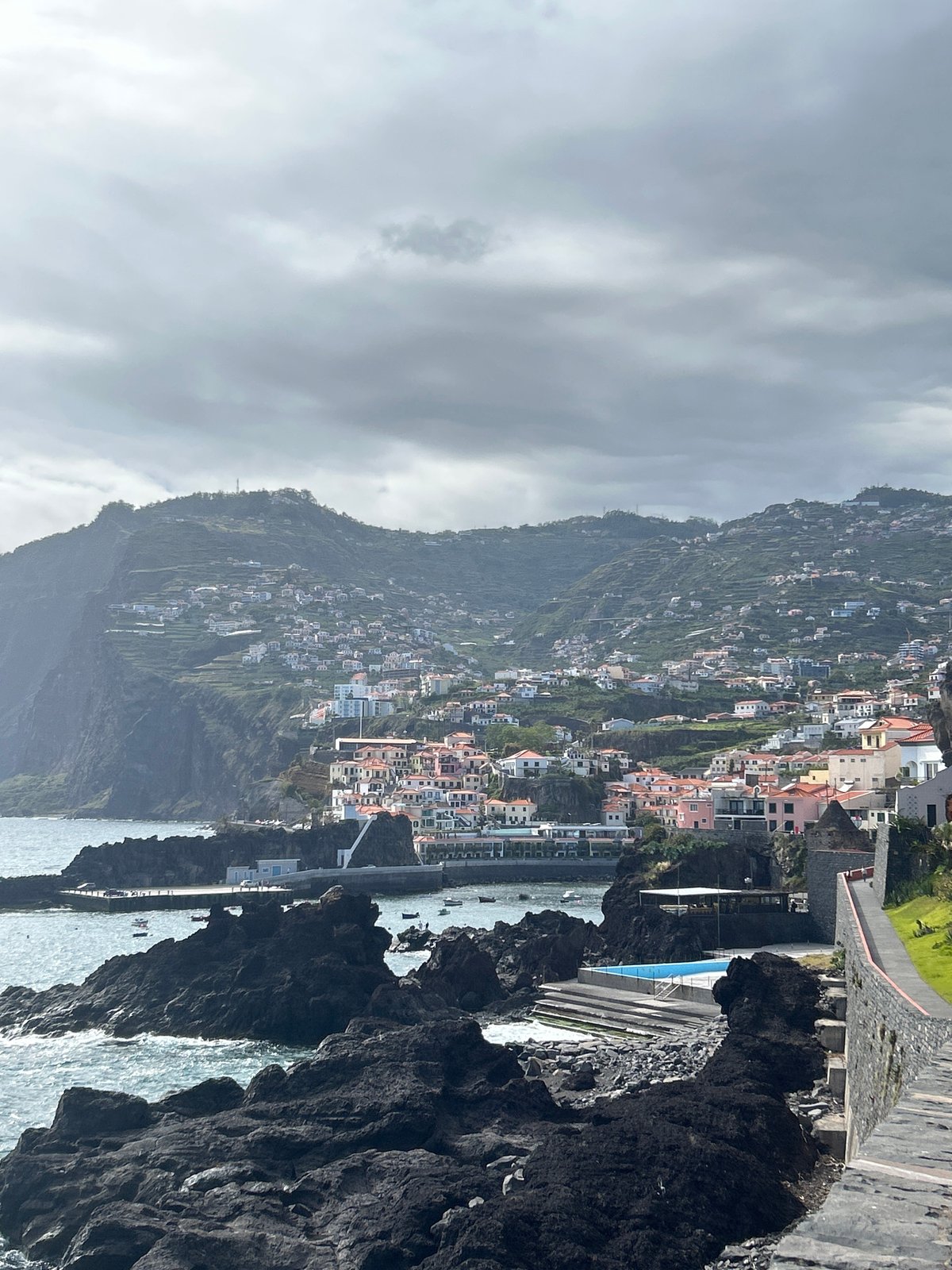Cloudy day view captured of hillside homes in Câmara de Lobos