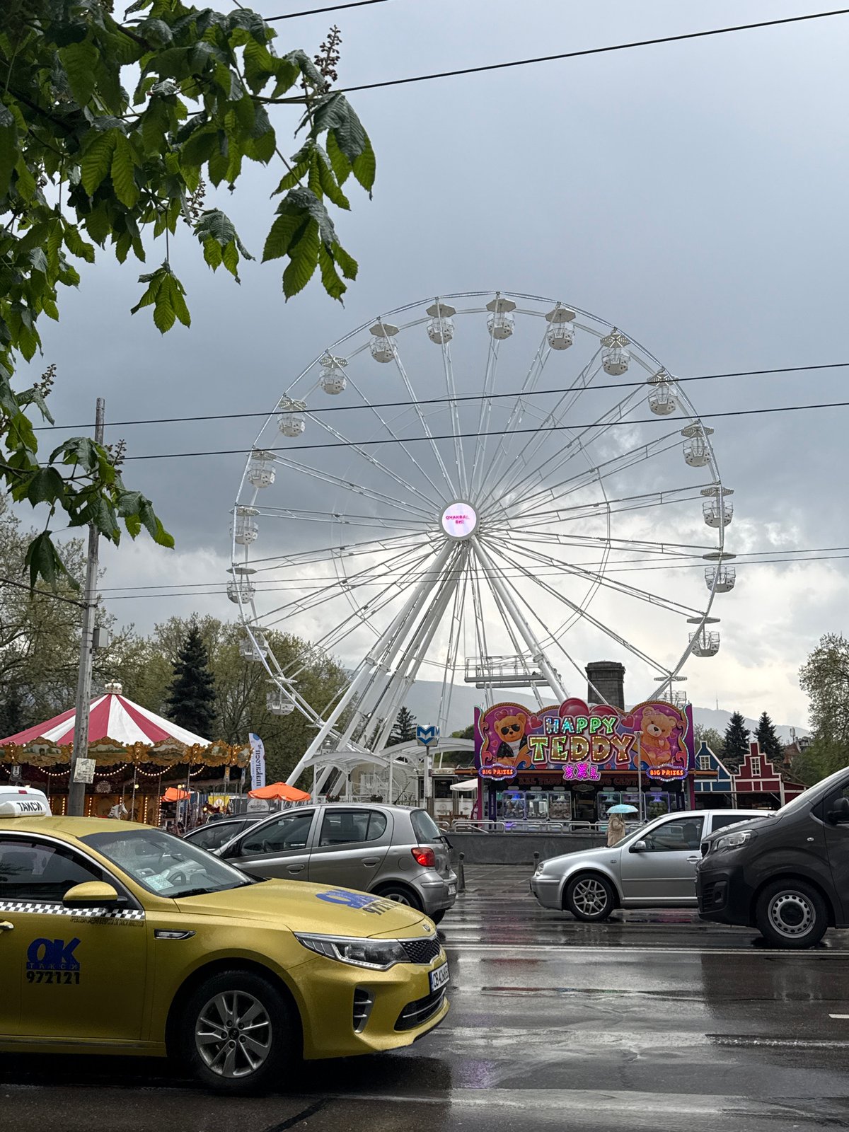White Ferris wheel operates under grey skies in Sofia
