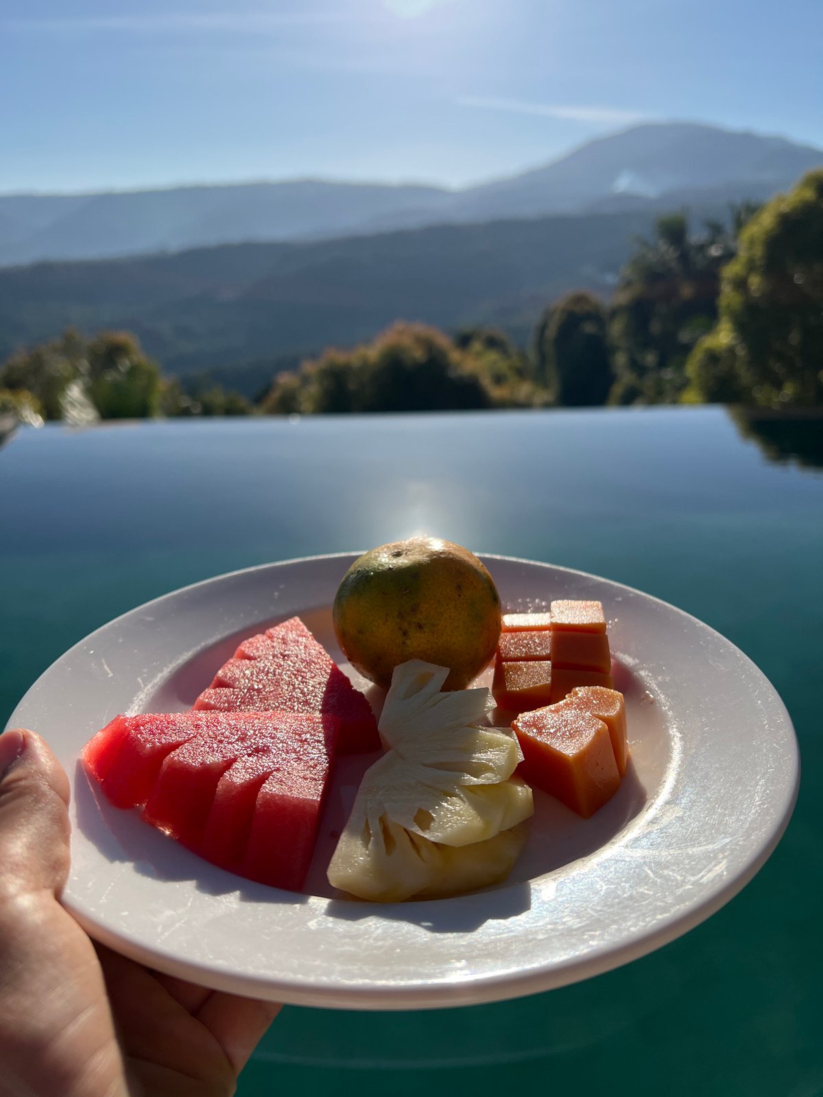 Villa breakfast spread with fruit and eggs, Busungbiu