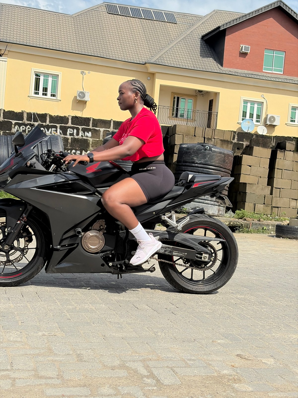 Motorcycles and a helicopter over a residential Igboefon neighborhood