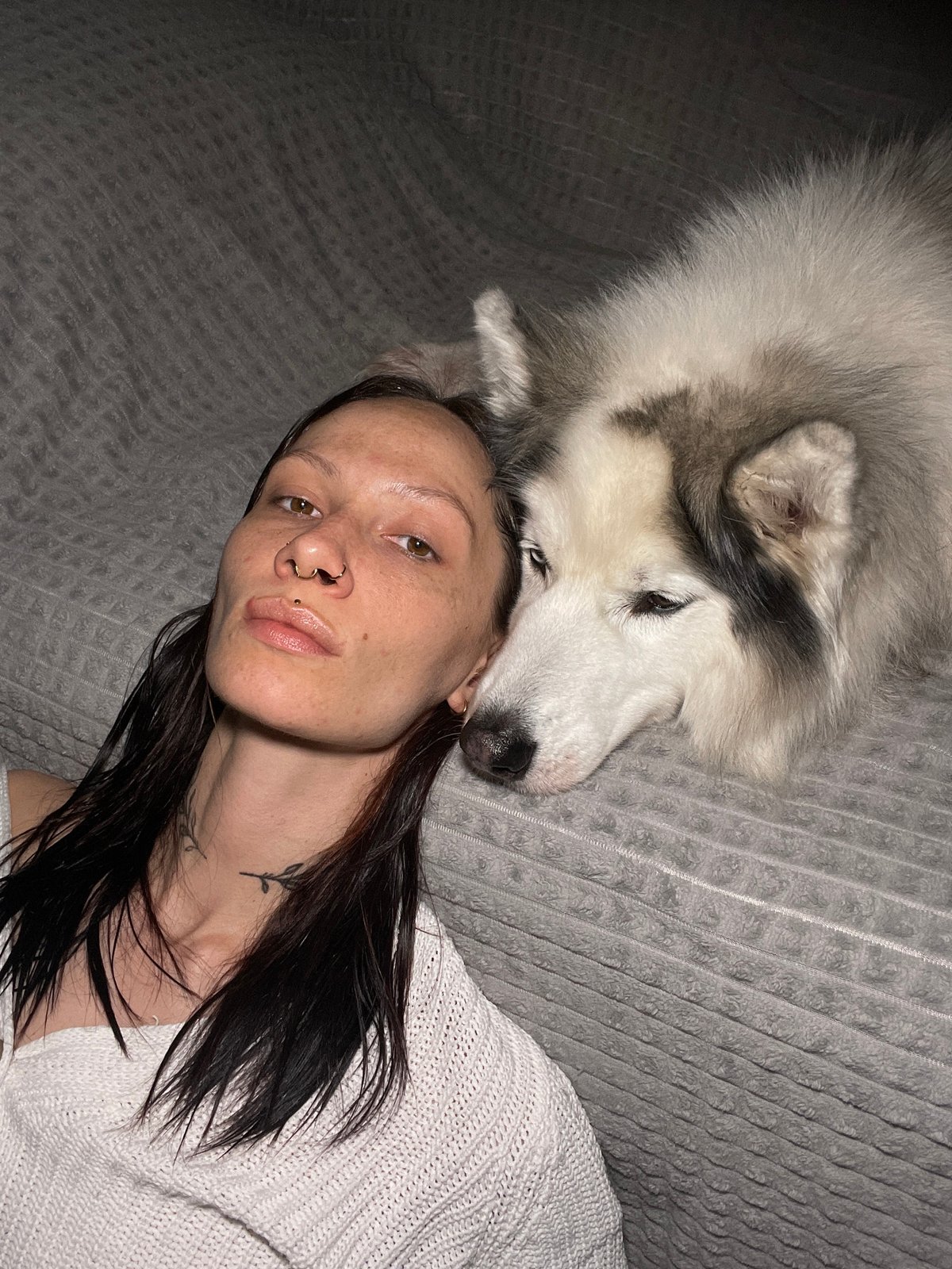 Woman relaxes with husky on blanket in Izhevsk