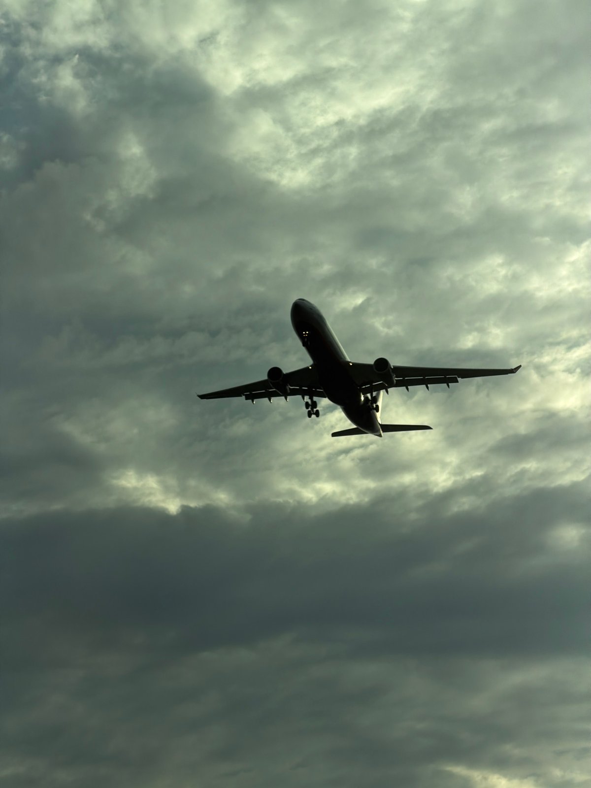 Passenger jet in silhouette over Saint Petersburg skies