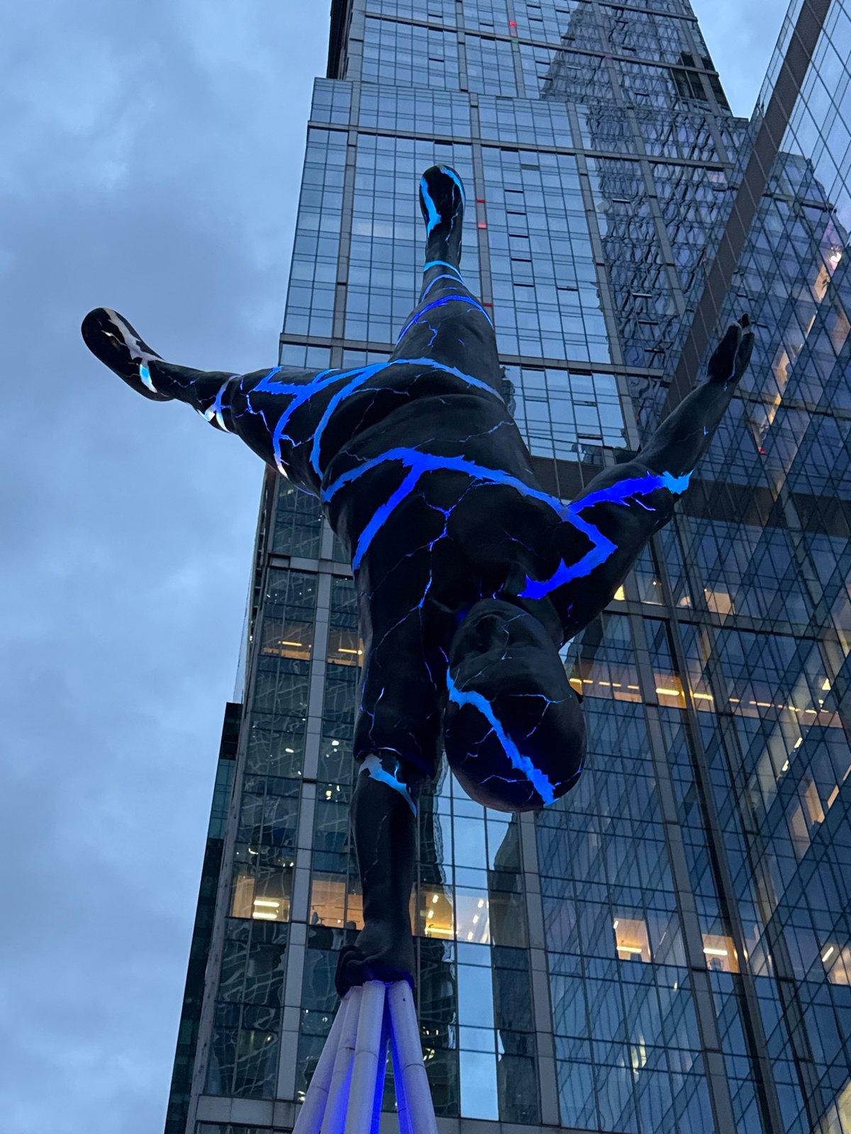 Glowing cracked sculpture suspended upside down in Moscow