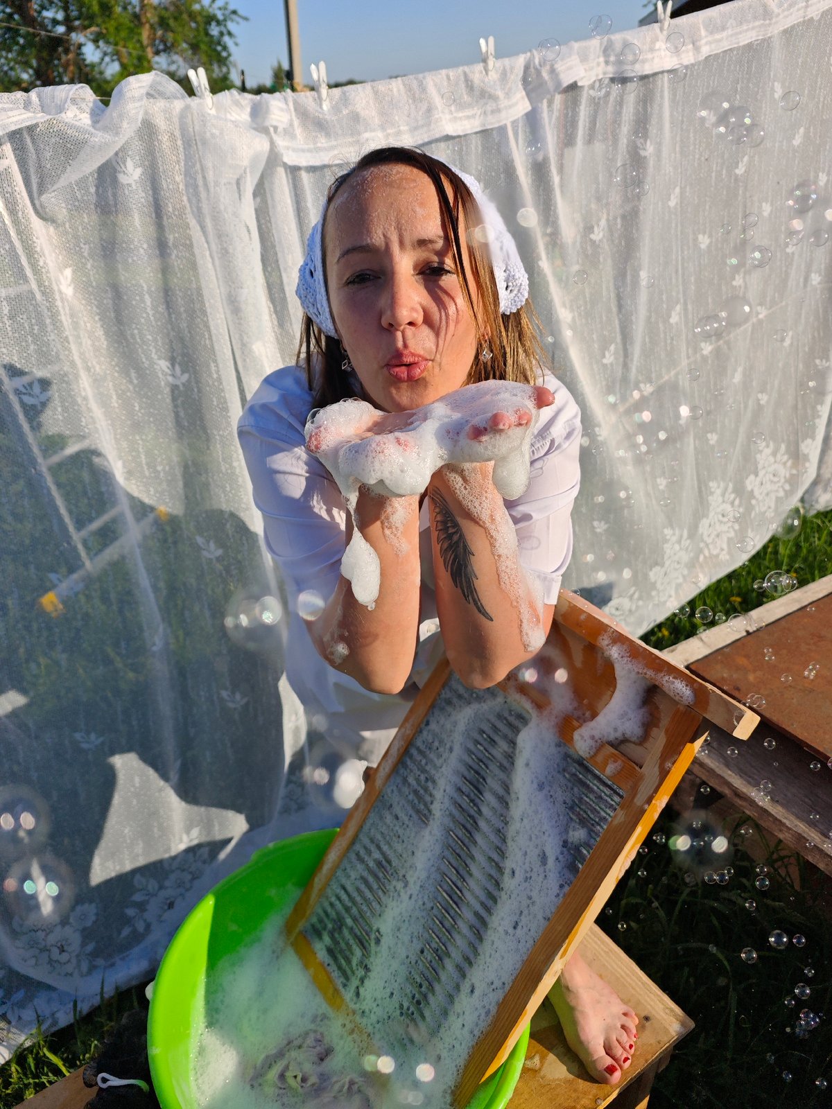 Woman does traditional laundry outdoors in rural Russian village