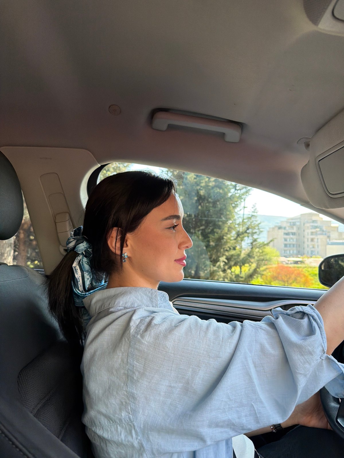 Two women photographed during car ride in Tbilisi