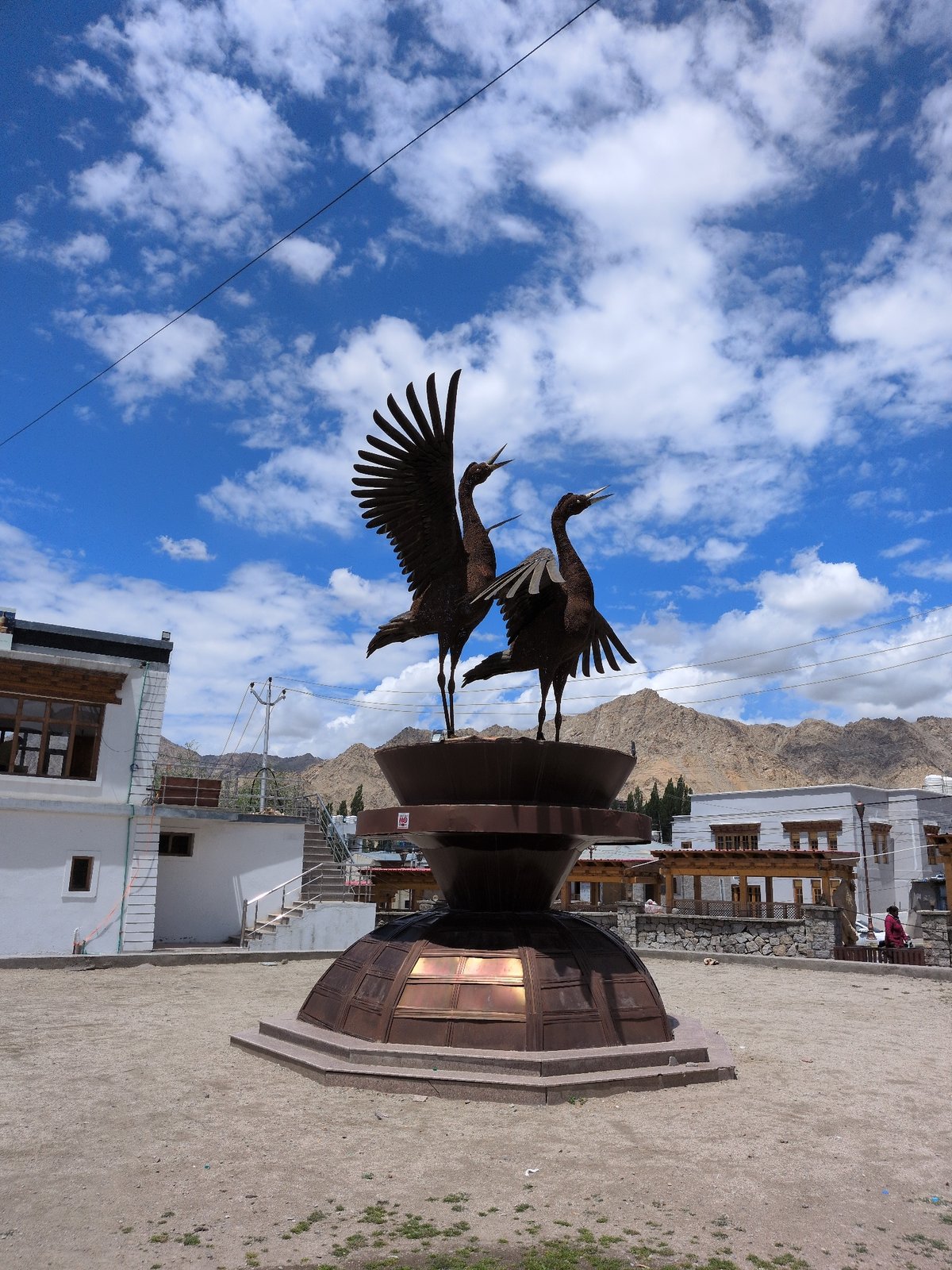 Bronze crane sculpture anchors a public square in Leh