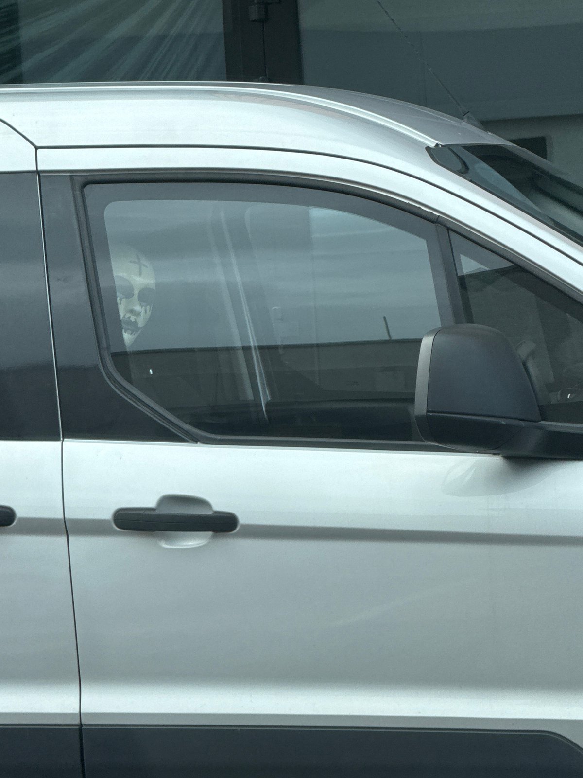 Skull mask spotted through a parked van window in Gdańsk