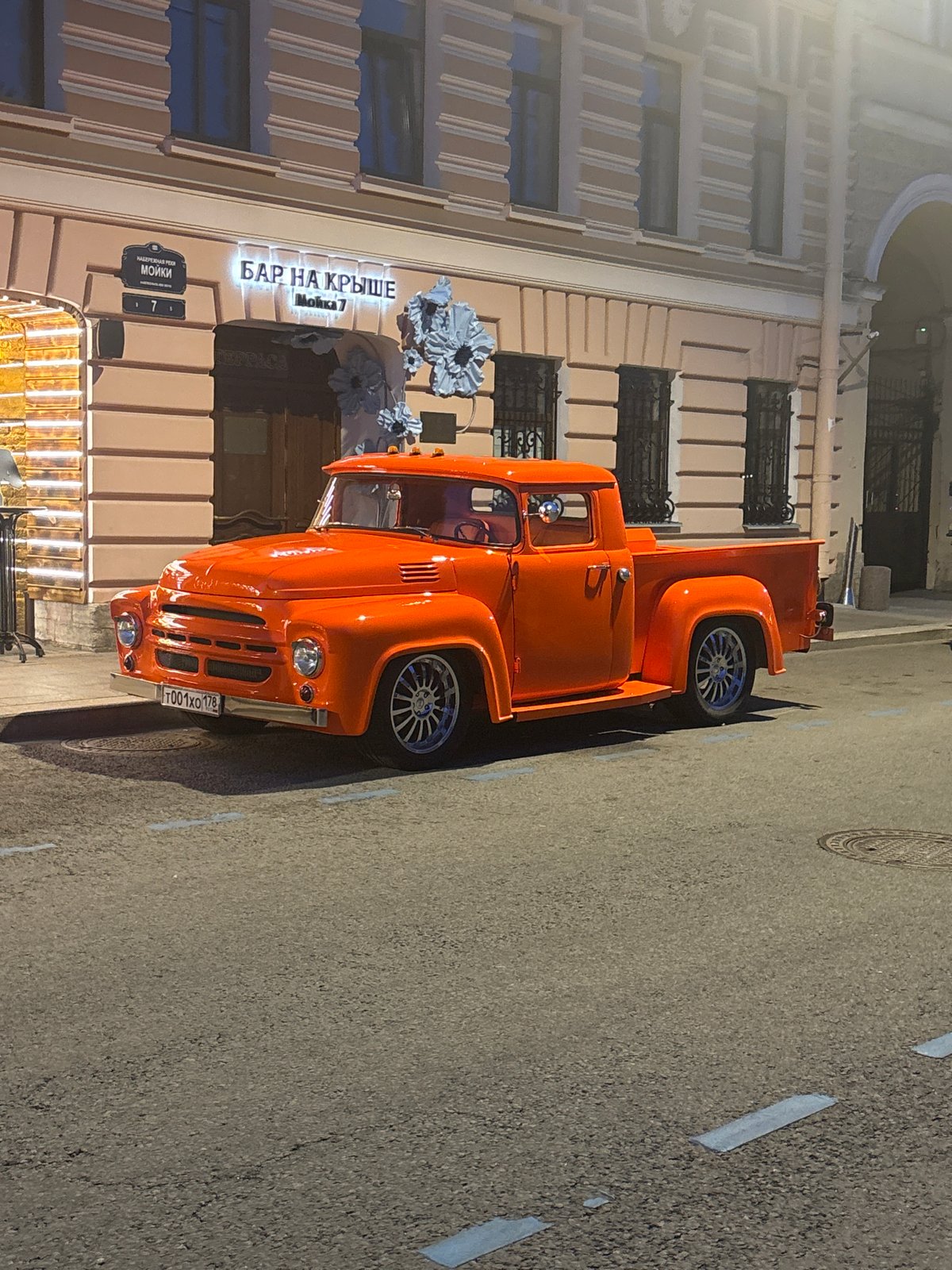 Orange vintage truck spotted near Russian rooftop bar building