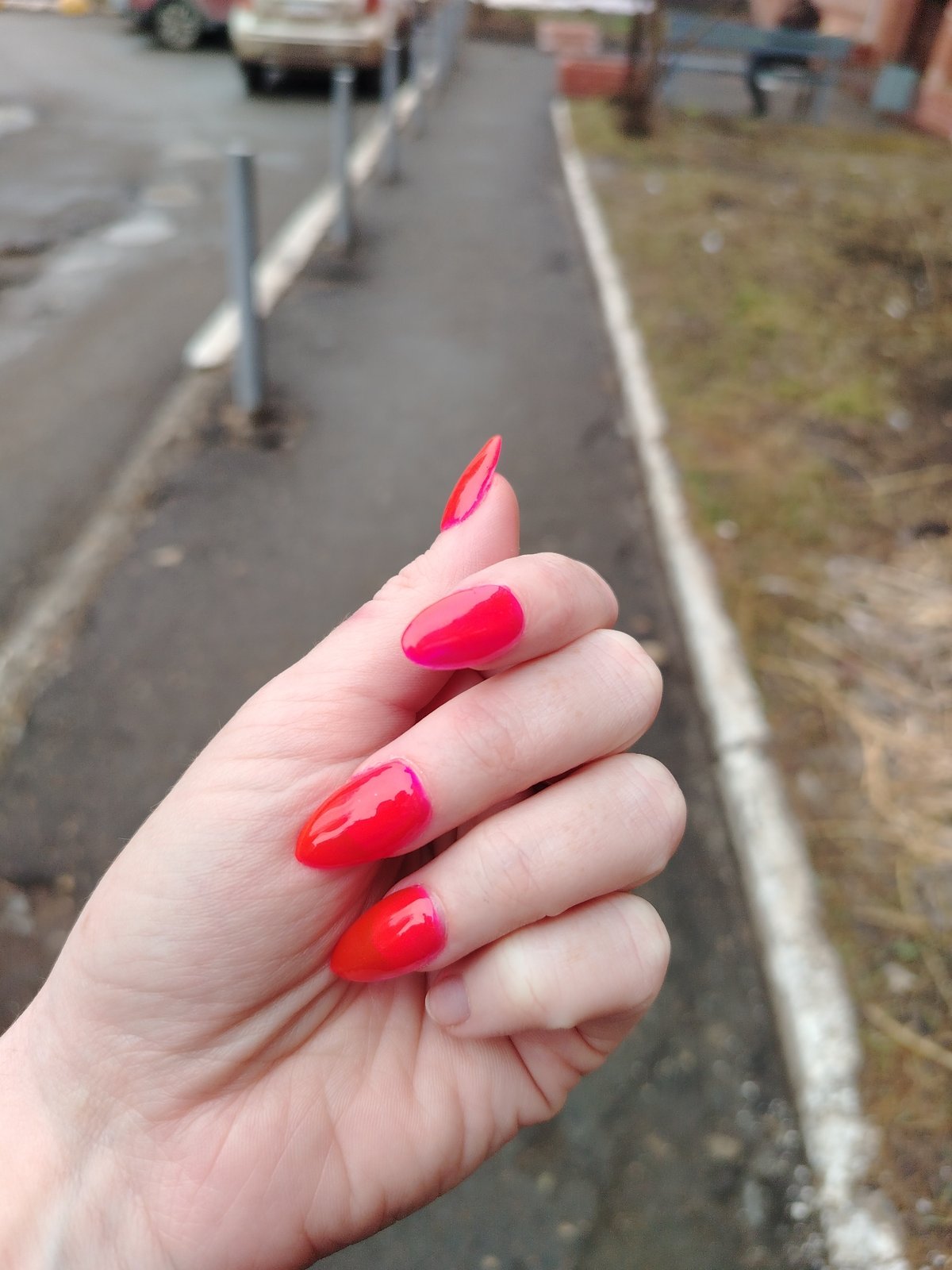 Woman's red manicured nails captured in Izhevsk street scene