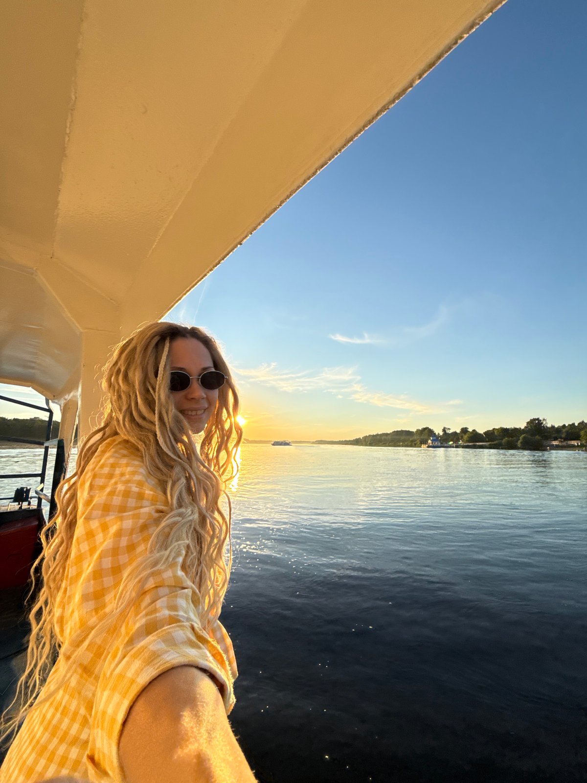 Passenger boat travels Volga River during sunset near Заволжье
