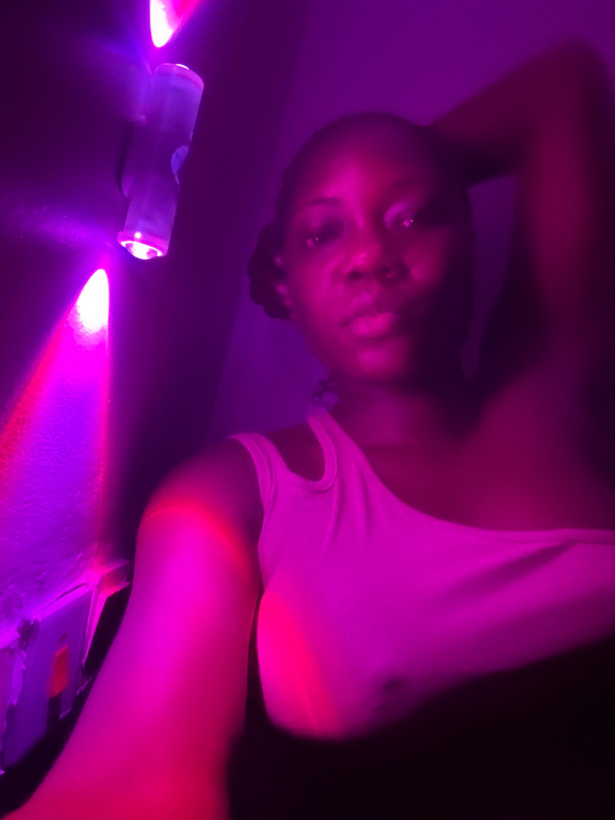 Private gathering with drinks and purple lighting in Nigeria