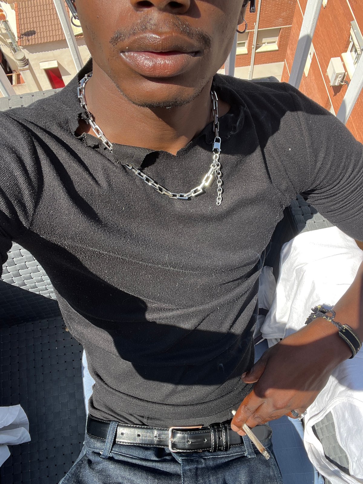 Person takes selfies on sunny Barcelona balcony terrace