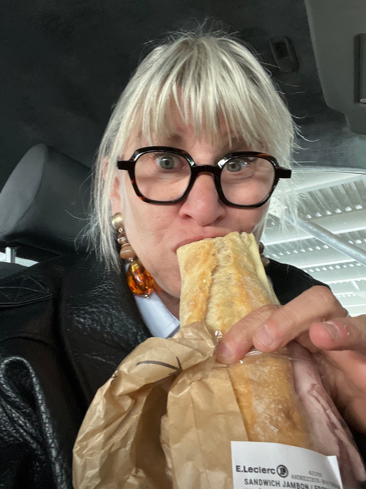 Person eats E.Leclerc ham sandwich in Andrézieux-Bouthéon