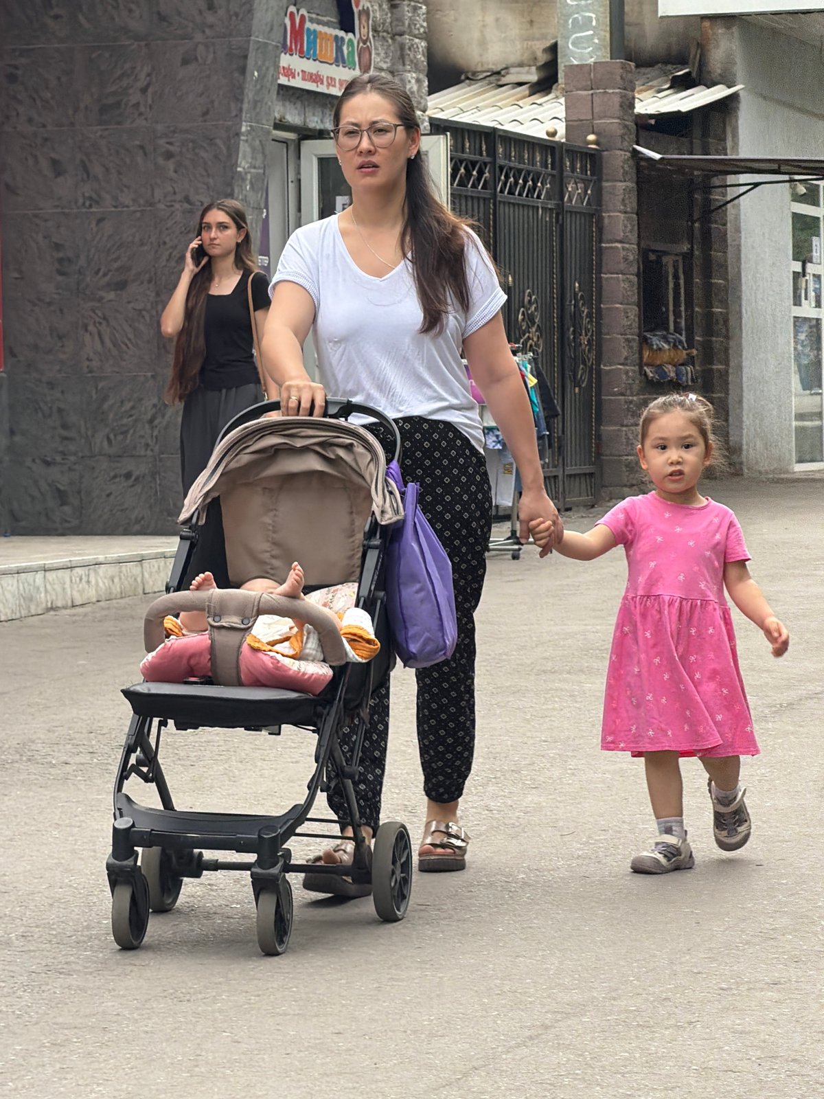 Pedestrians navigate city streets during midday weekend activity