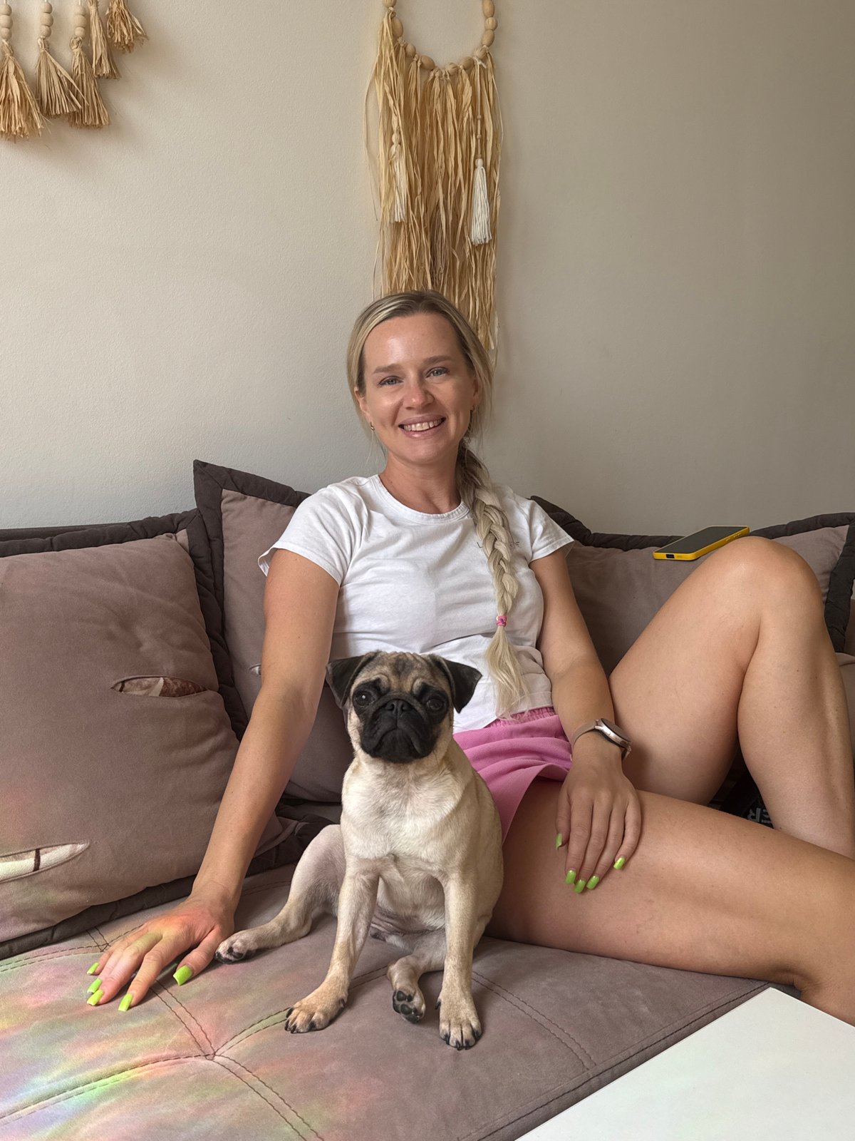 Casual couch moment with a pug, all smiles.