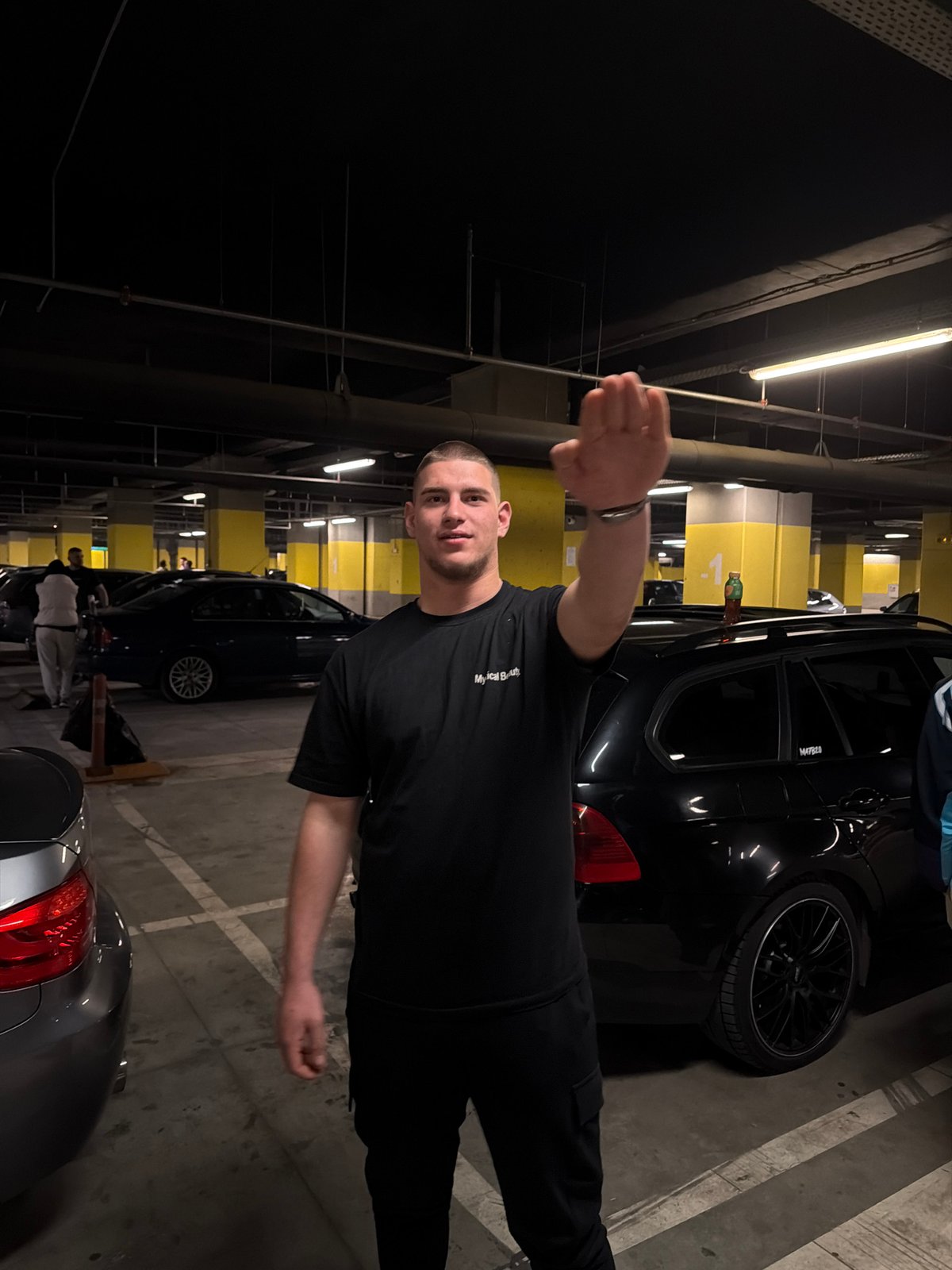 Young men pose for photos in Sofia parking garage