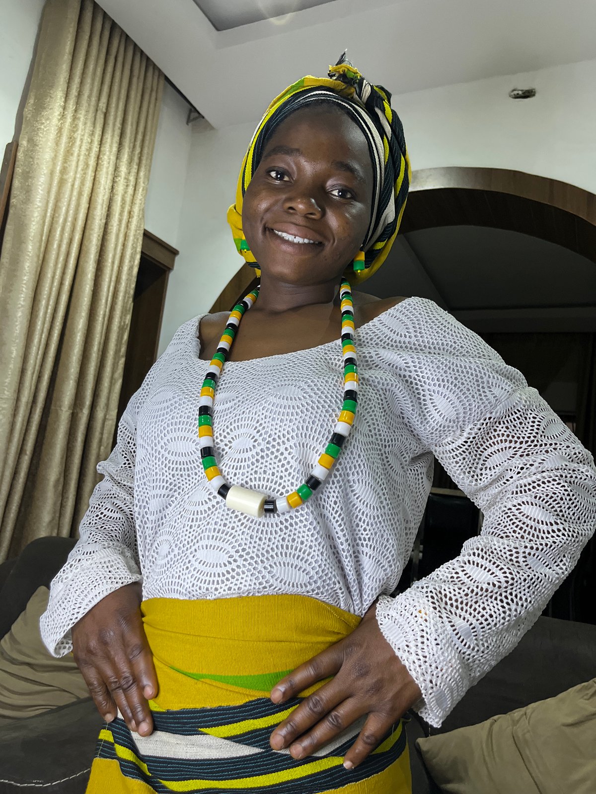 Woman in traditional Nigerian dress photographed in Jos home