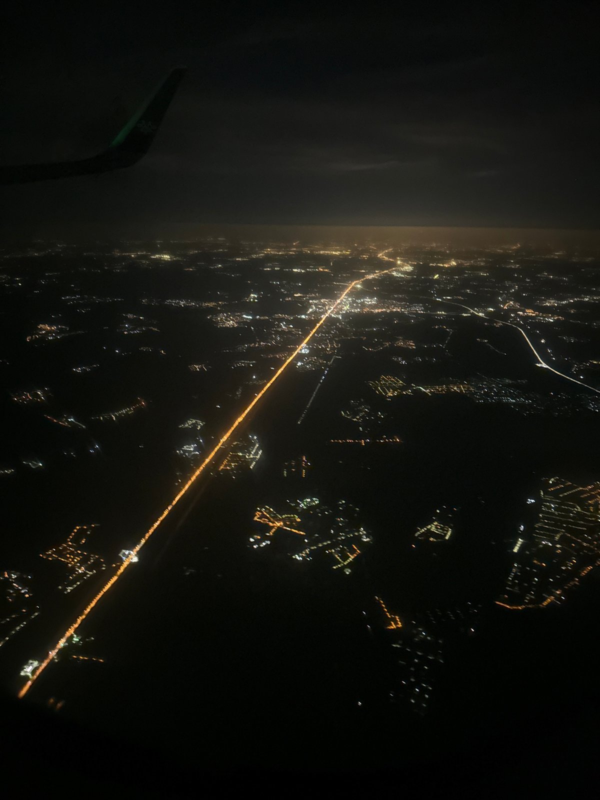 Passenger documents nighttime aerial view of illuminated Moscow from aircraft