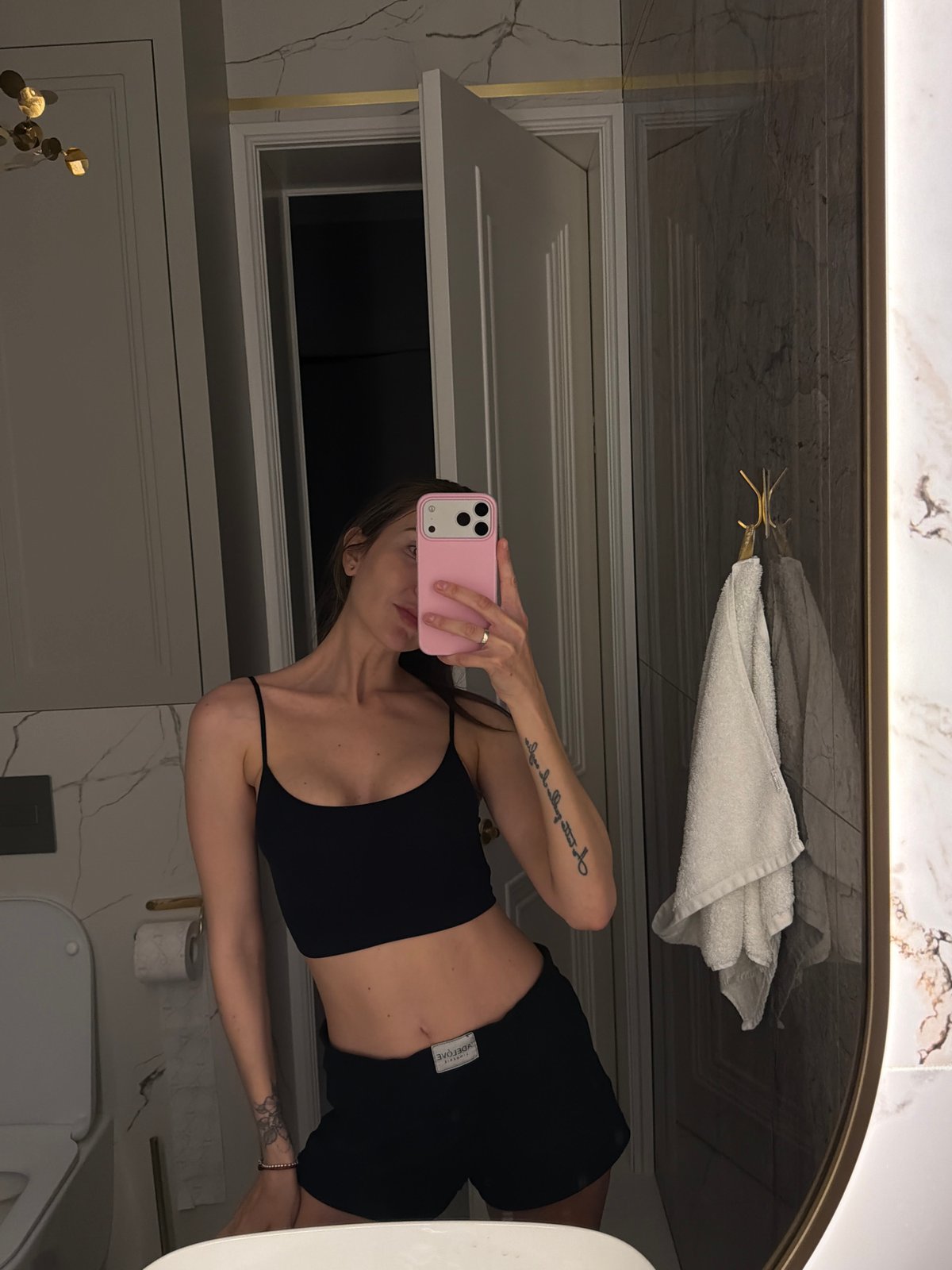 Person takes bathroom mirror selfies in Krasnoyarsk