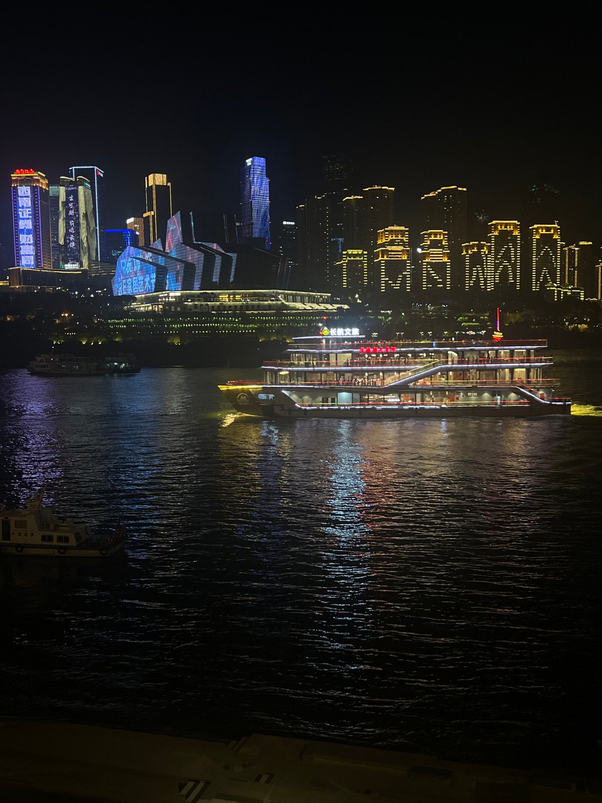 Chongqing's Yangtze riverfront lights up after dark