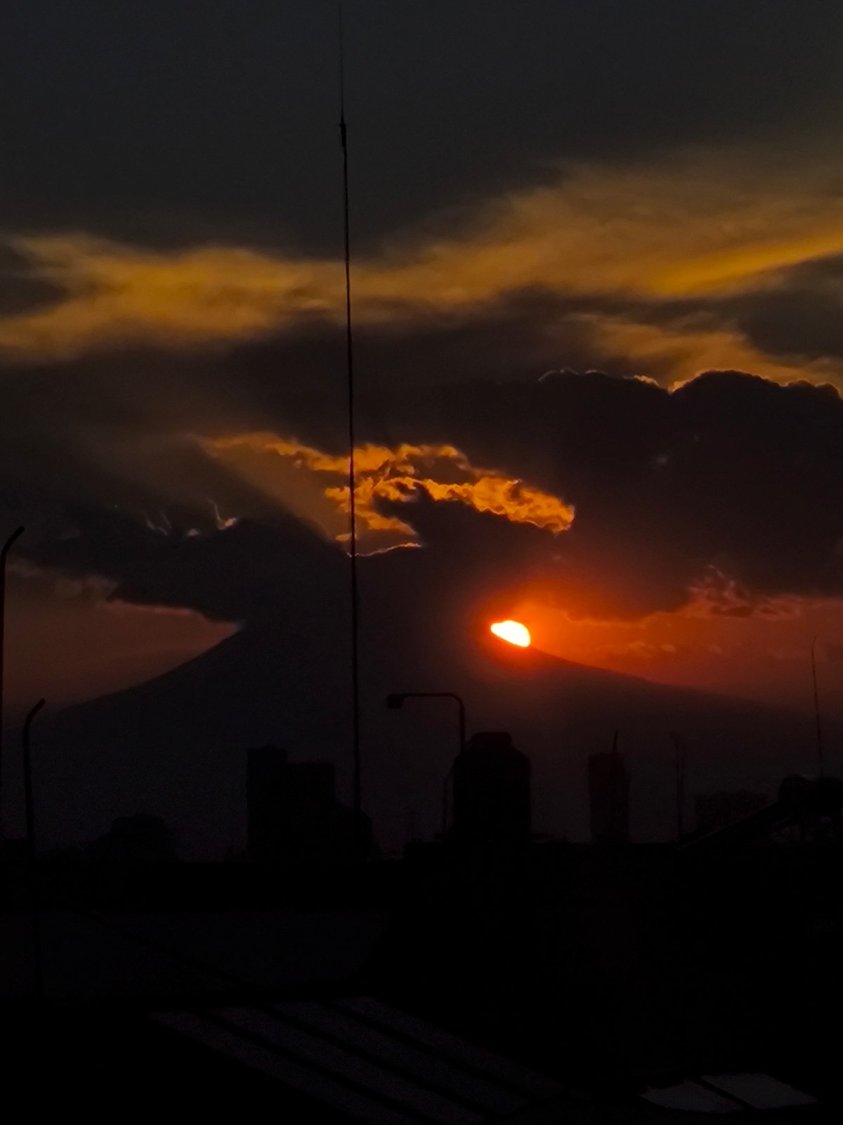 Sunset over Puebla cityscape with Popocatépetl volcano backdrop