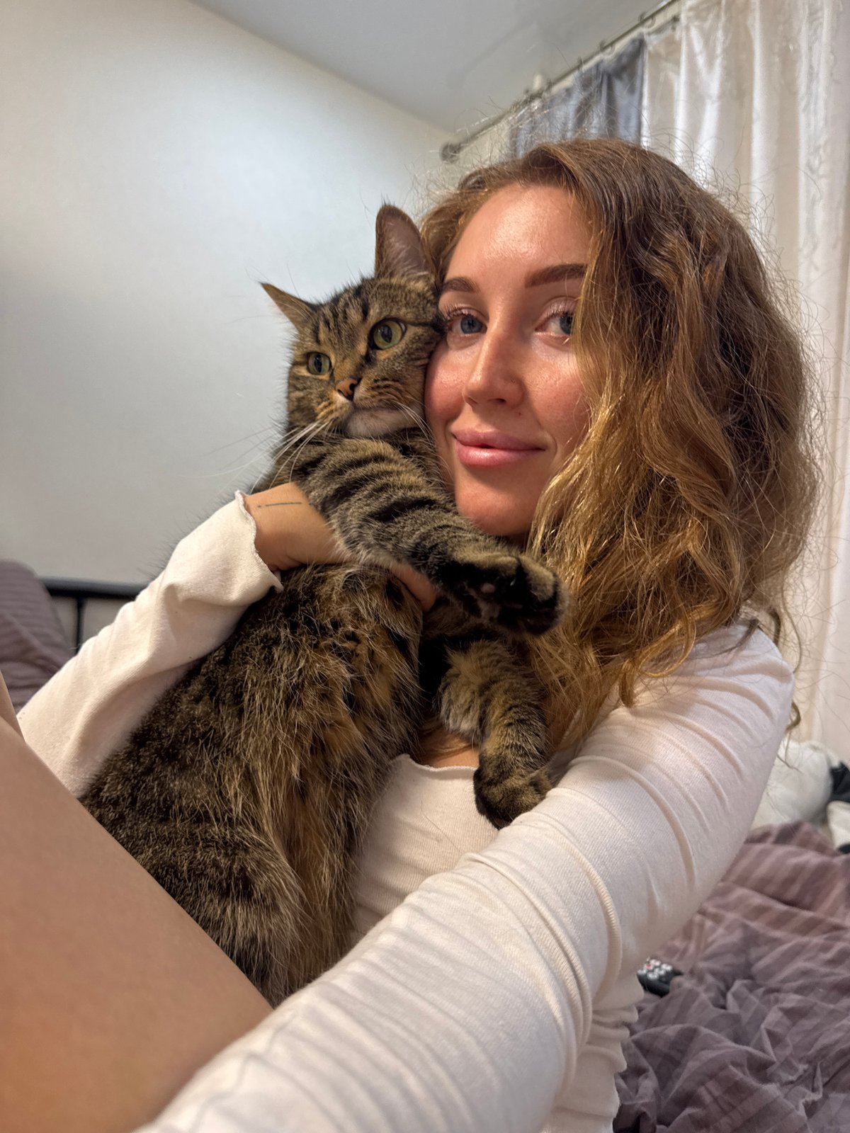 Woman poses with cat and dog in Chaikovsky home