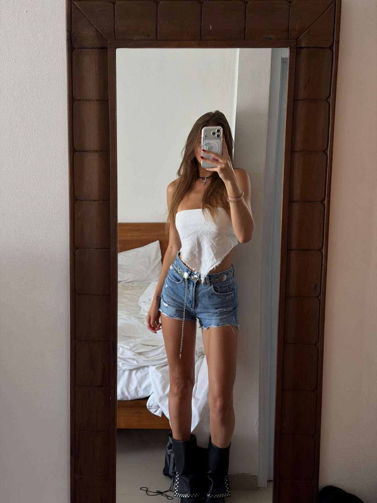 Person takes mirror selfie in North Kuta room