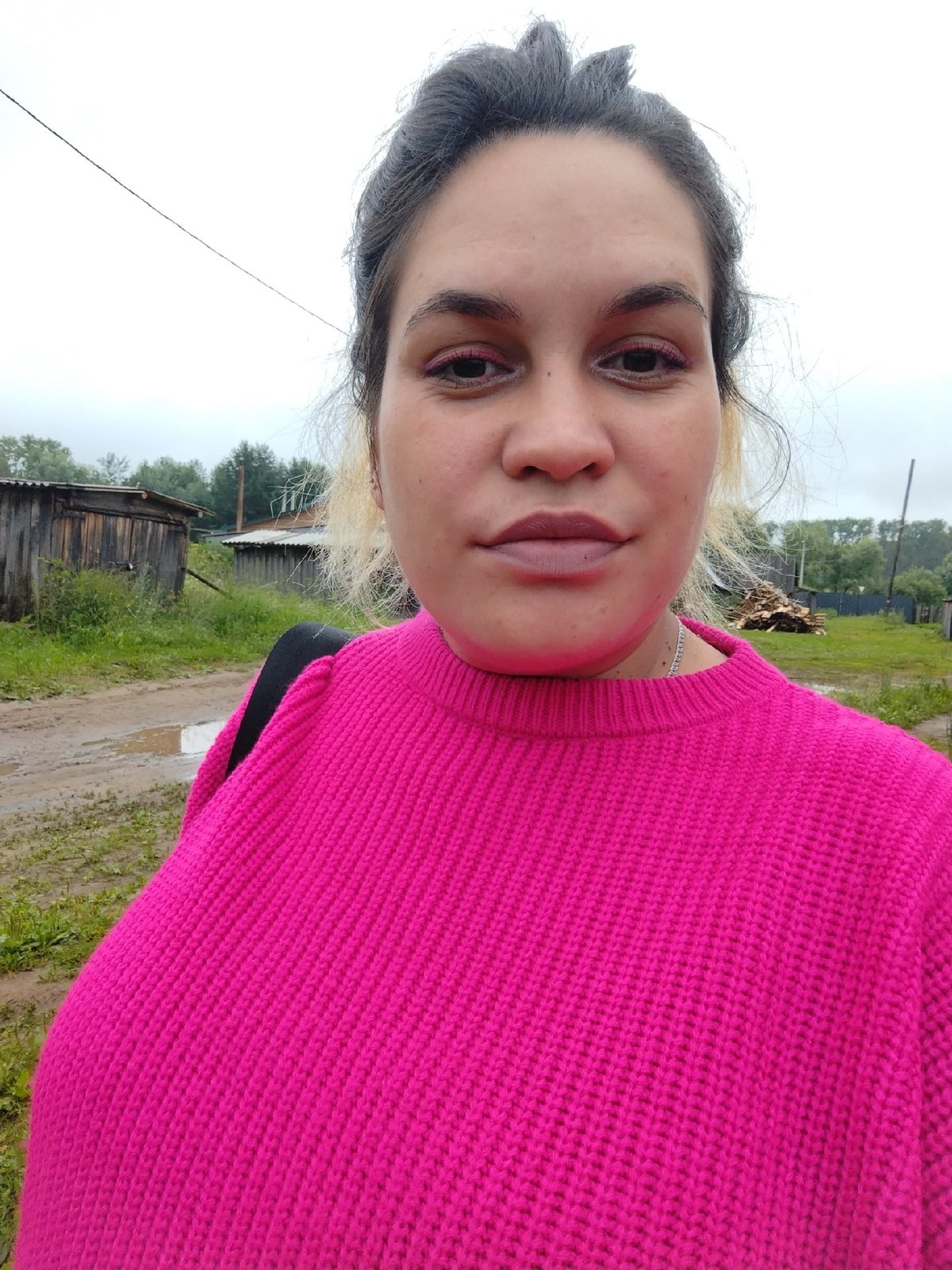 Pink sweater, parked car, cloudy day in Rusalevka