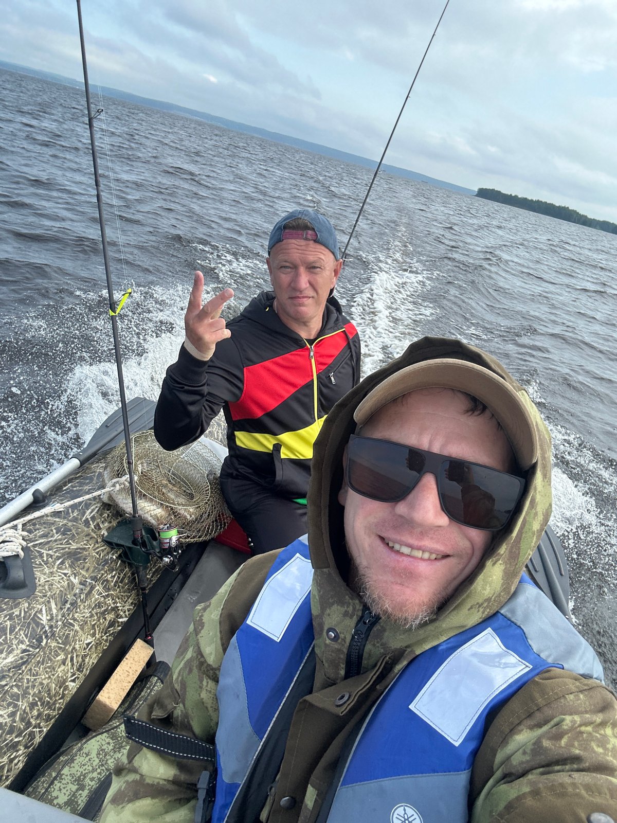 Inflatable boat trip across a Russian lake, July morning