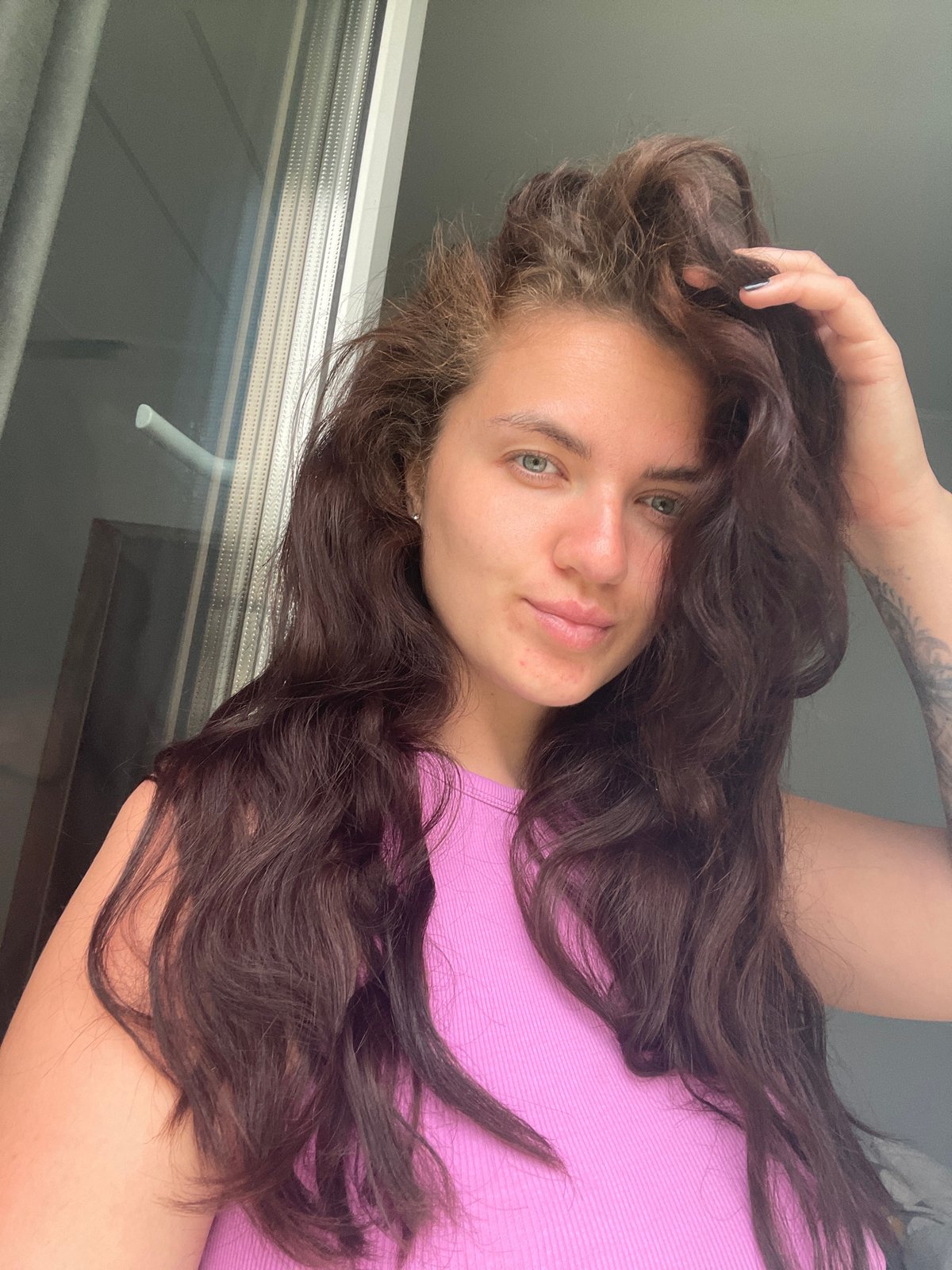 Woman takes playful selfies near window in Russia