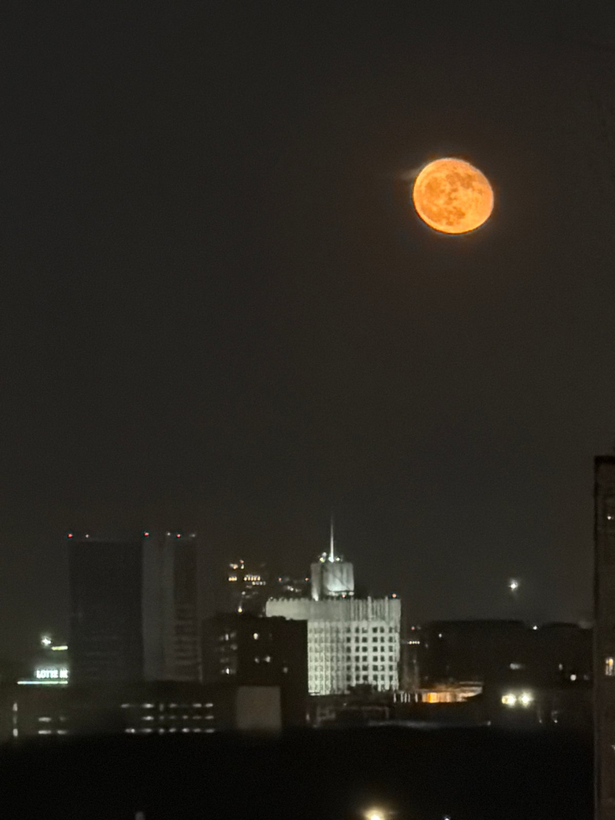 Orange full moon rises over Khimki cityscape Saturday night