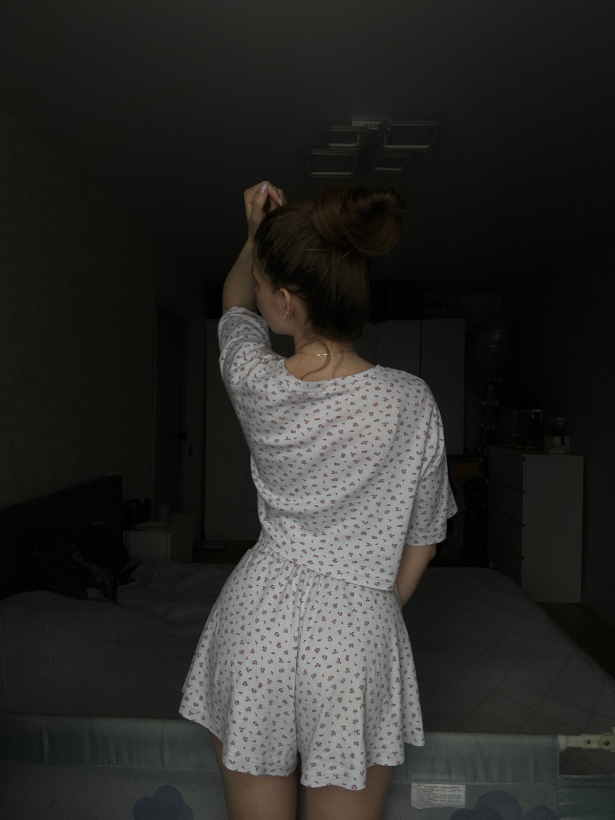 Woman photographed in bedroom setting in Klin, Russia